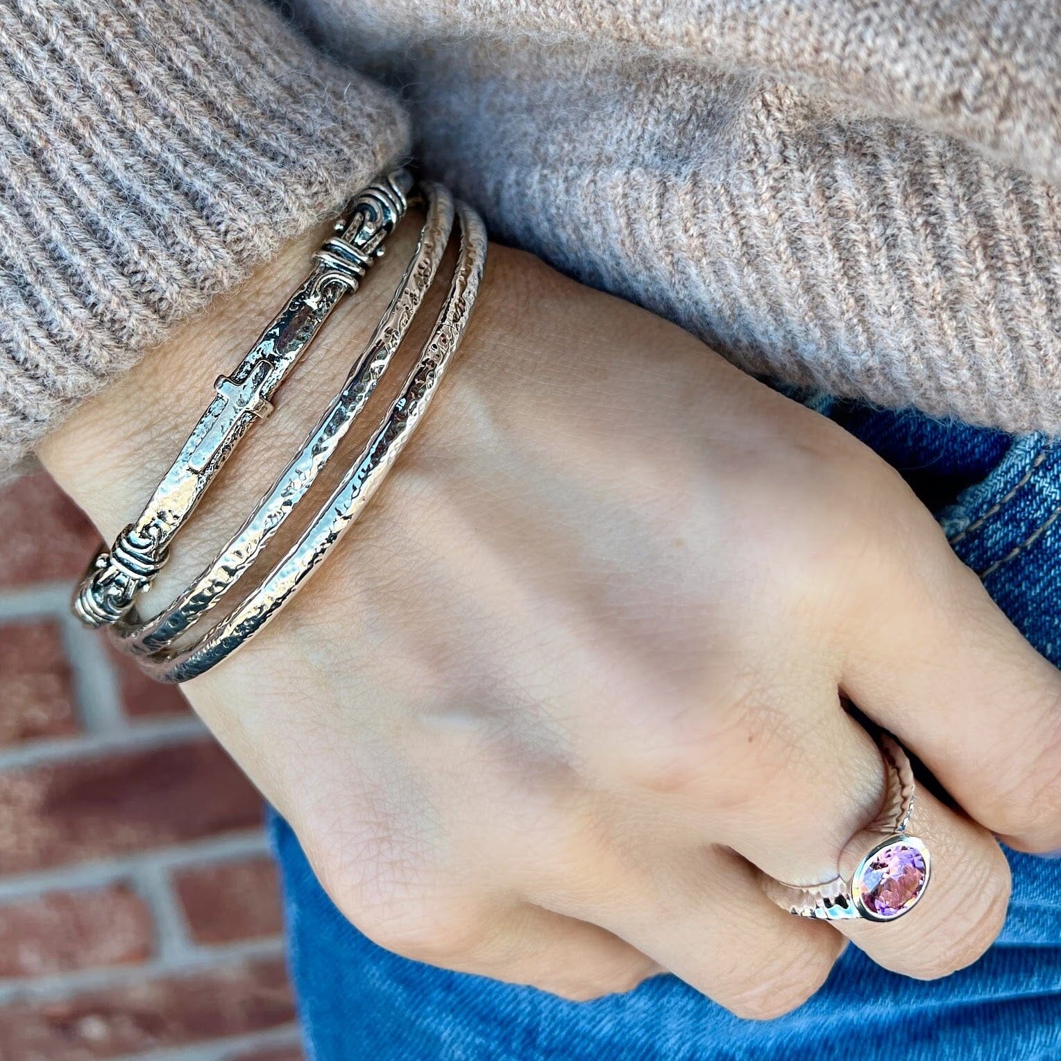 Heritage of Faith Bracelet paired with two silver hammered bangles