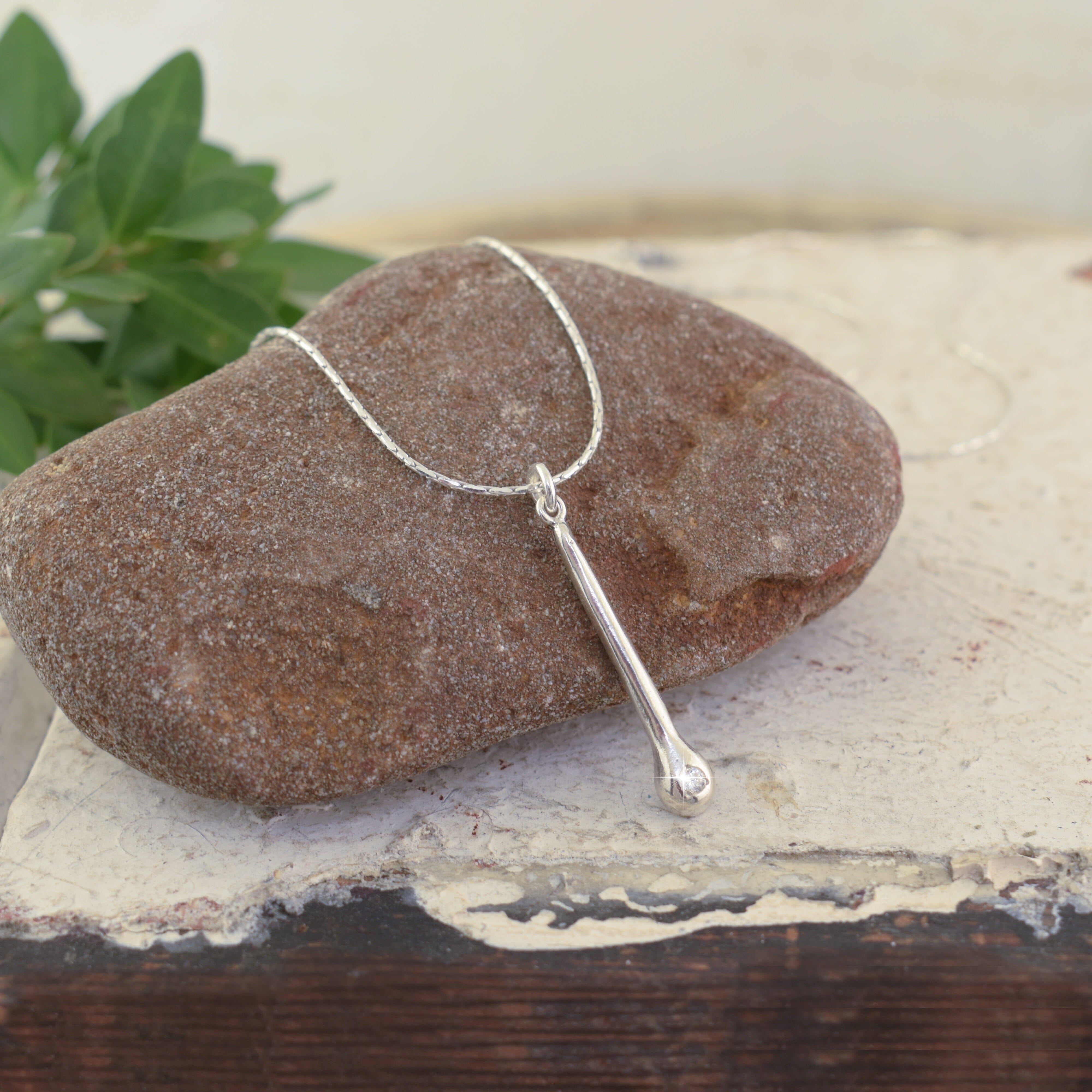 sterling silver drop shaped pendant with a clear CZ stone at the bottom