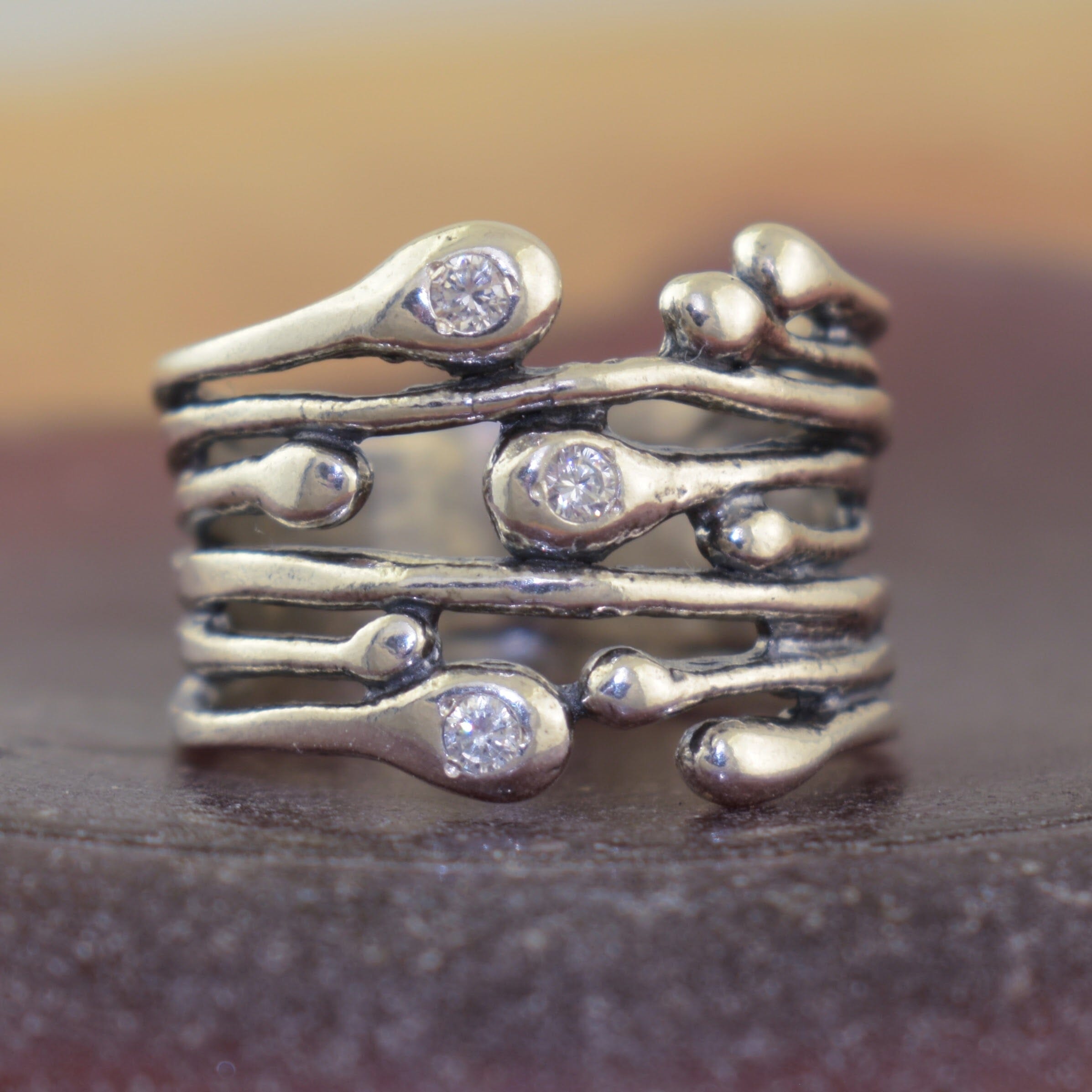 organic drop shaped silver with clear CZ stones 