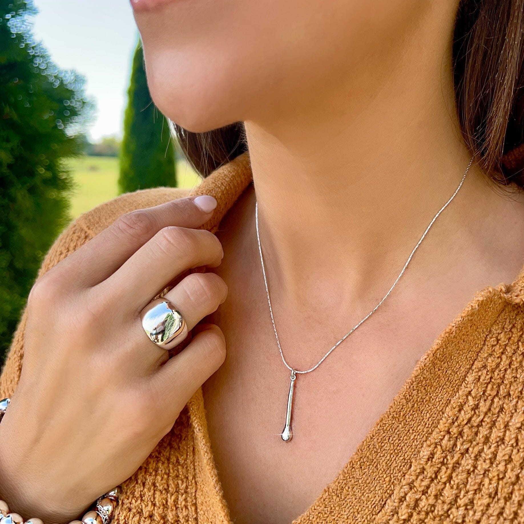 delicate necklace featuring a ling silver pendant with a small round cz stone
