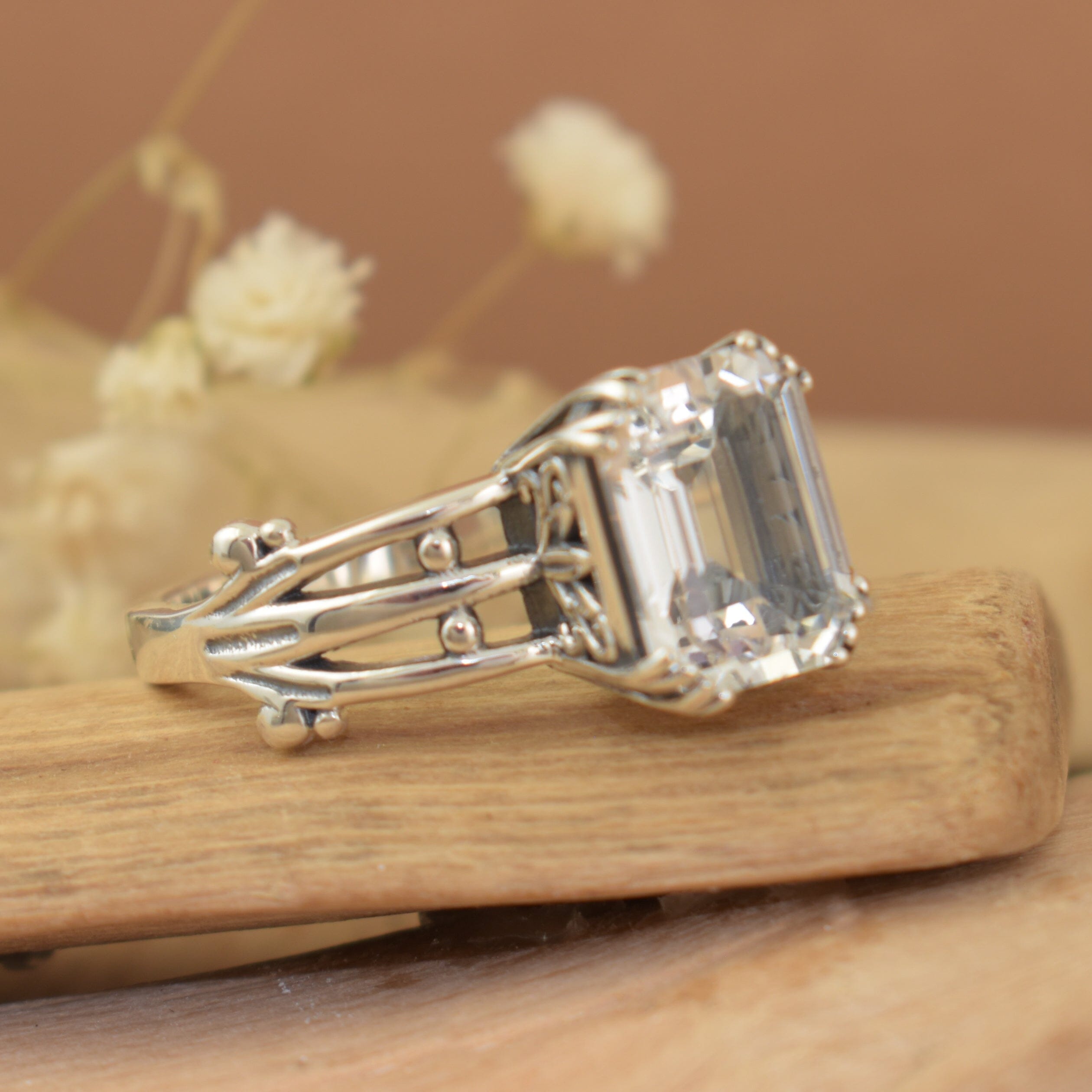 Handcrafted sterling silver ring with detailed band and emerald cut cz stone