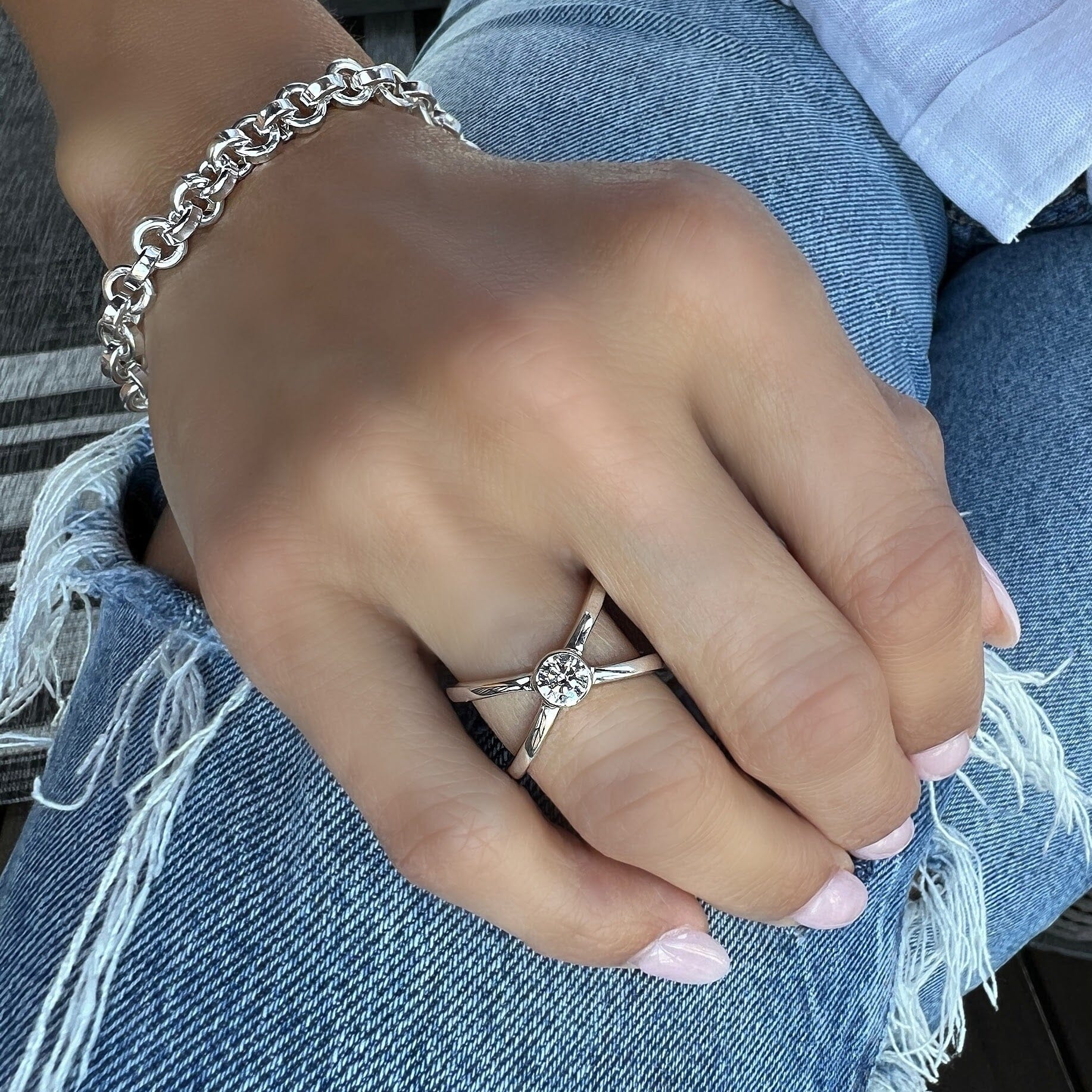 sterling silver criss cross ring with a CZ stone in the center paired with Bonita bracelet