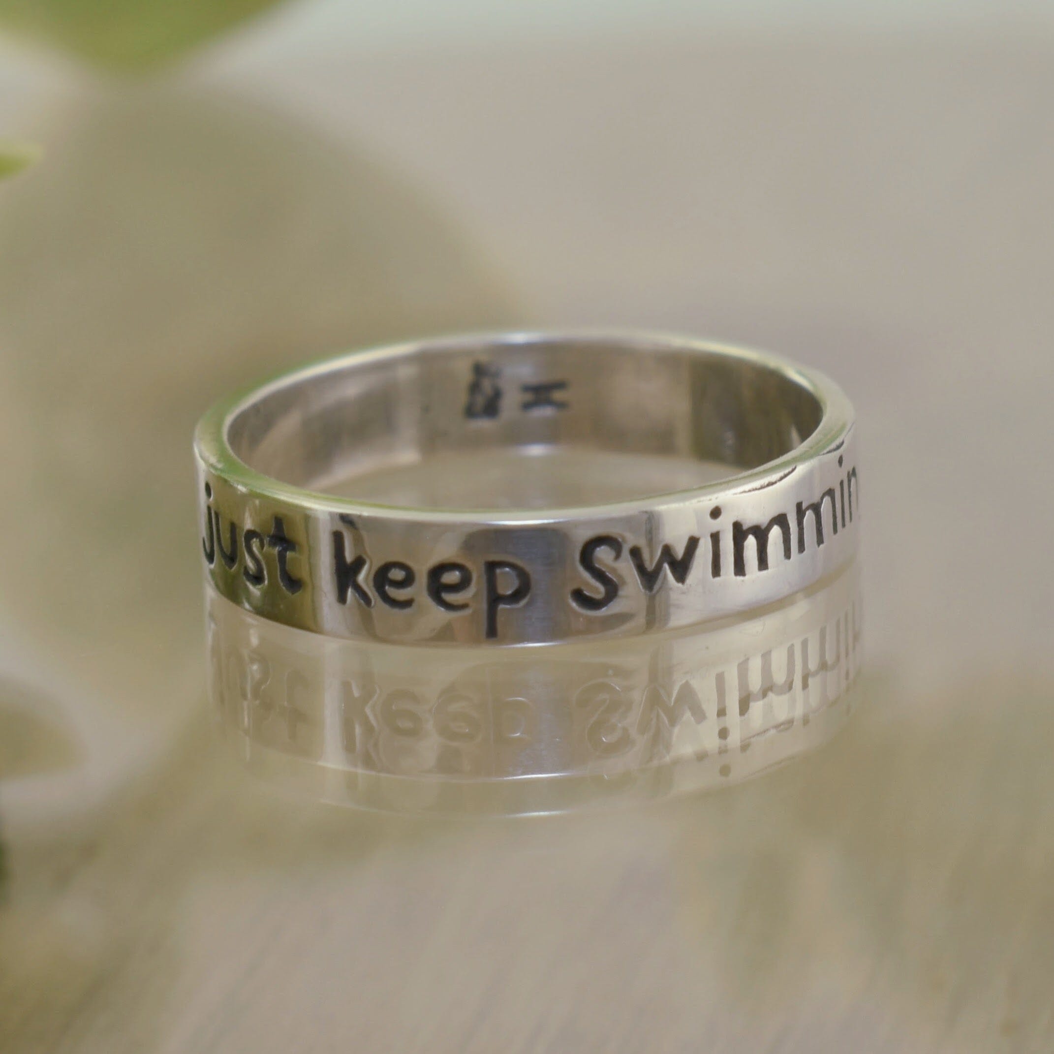 .925 sterling silver ring engraved with phrase from Finding Nemo "just keep swimming"