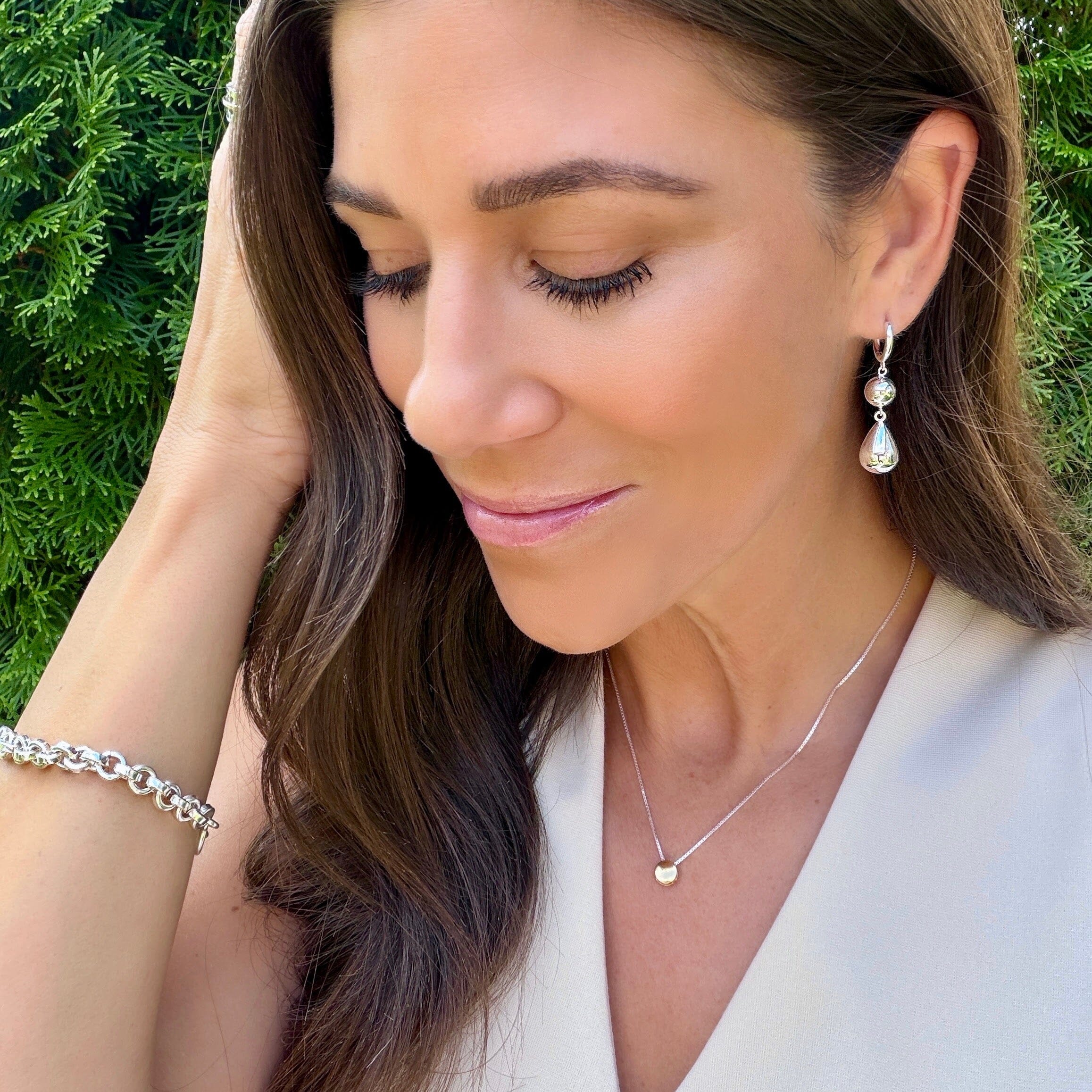high polished silver bead earrings suspended from a huggie style hoop