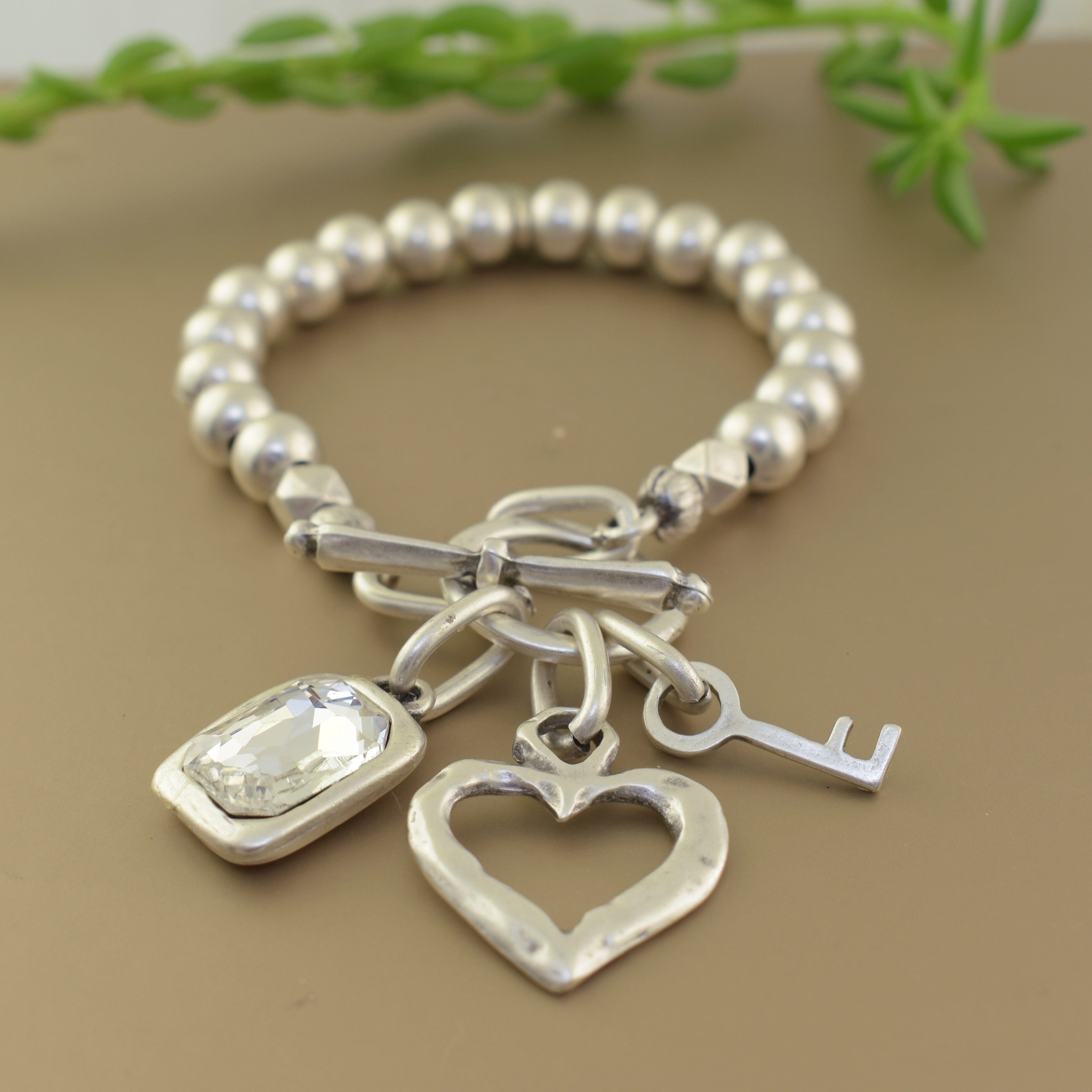 Clear stone heart and key charm bracelet
