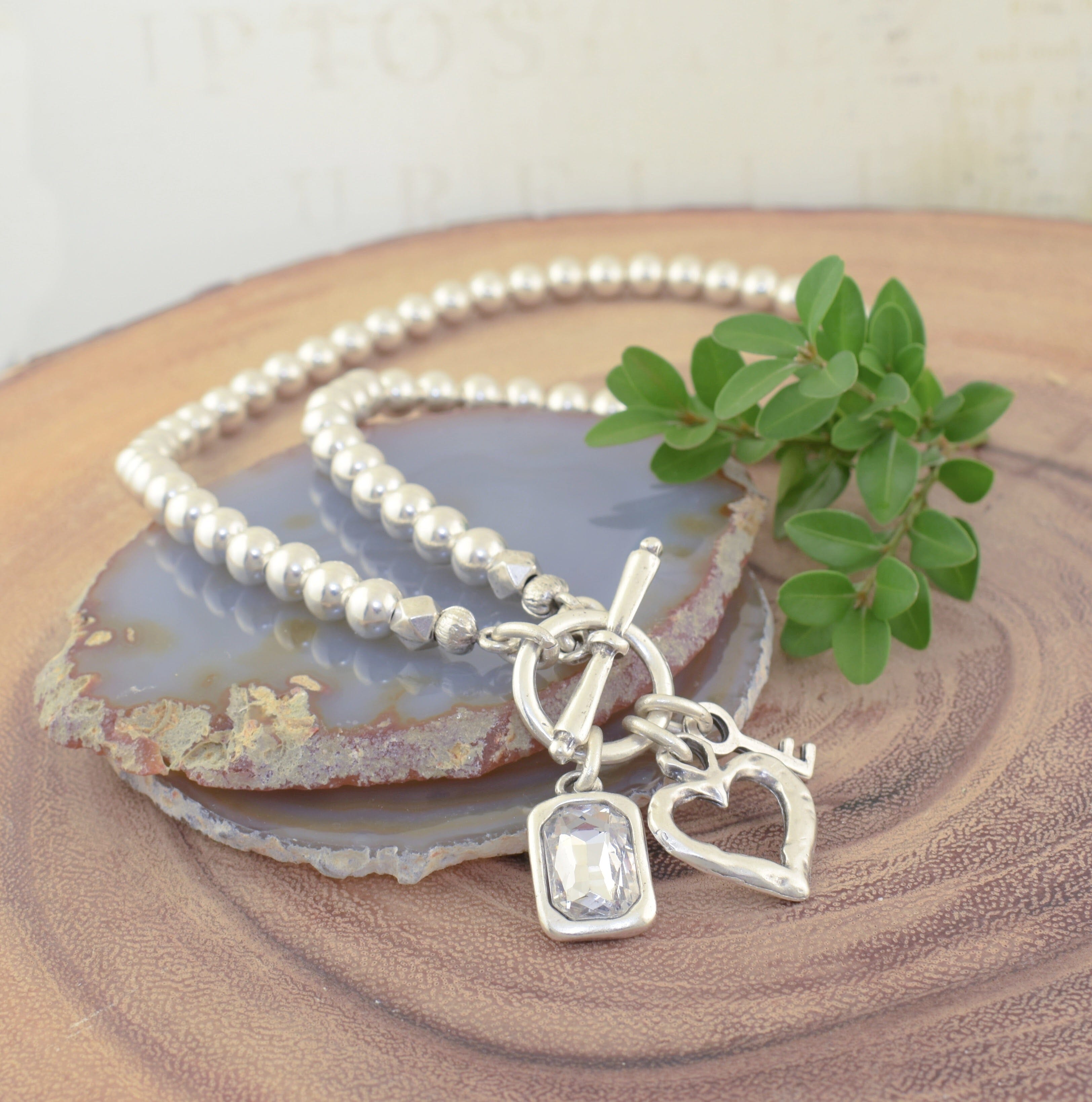 Toggle Necklace with a heart, key and a set crystal