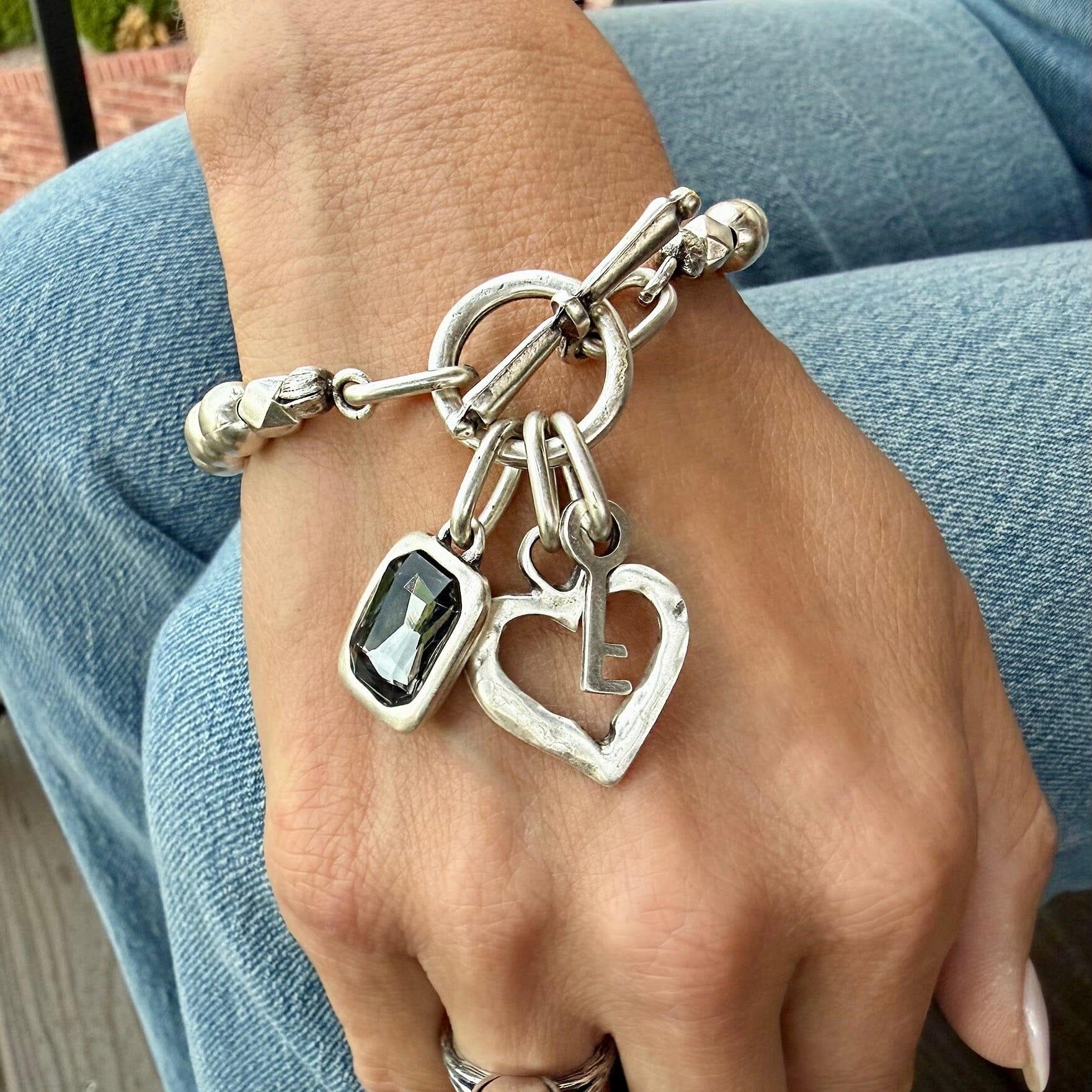 silver plated zamak lock and key bracelet with grey stone