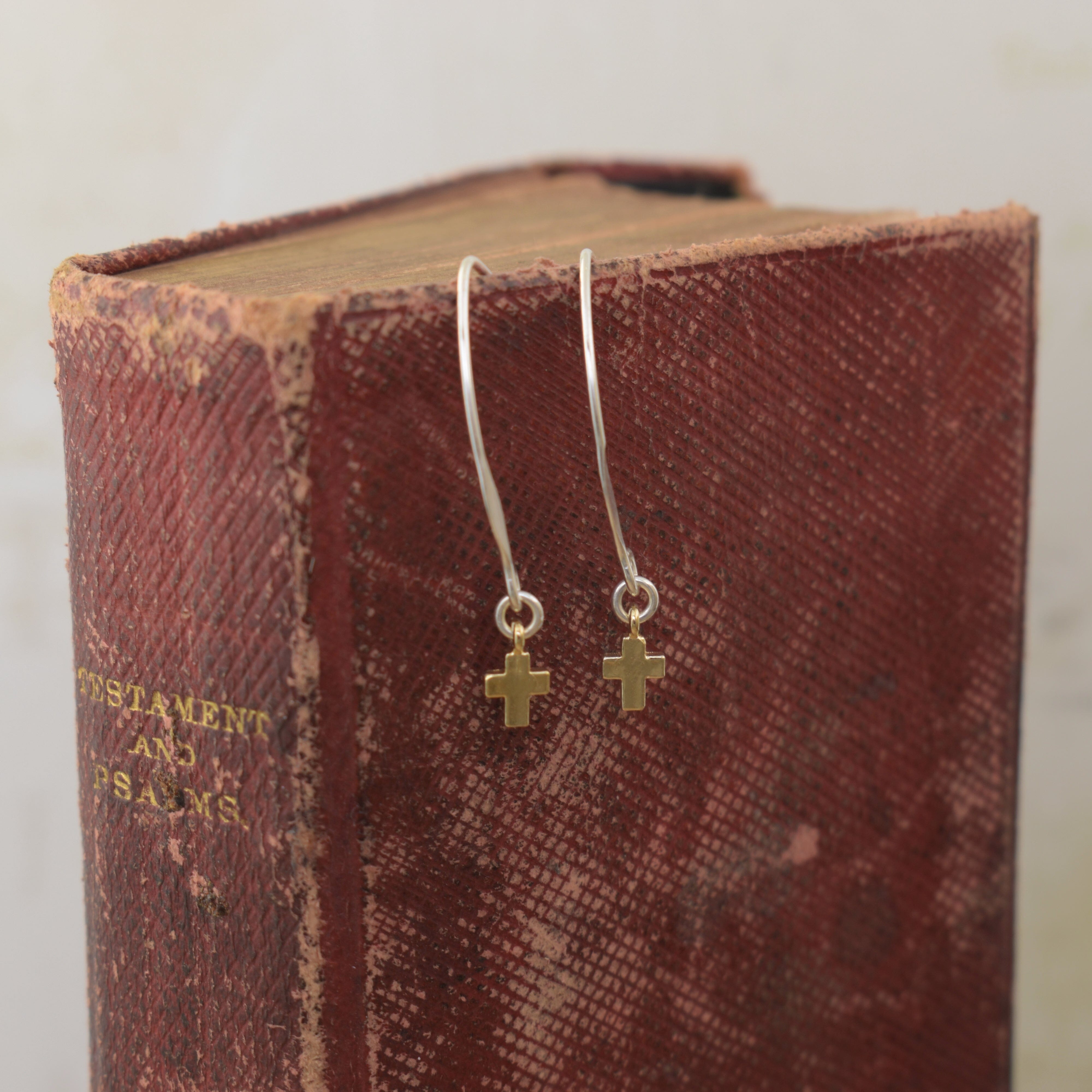 sterling silver v wire earrings featuring a dainty gold vermeil cross dangle