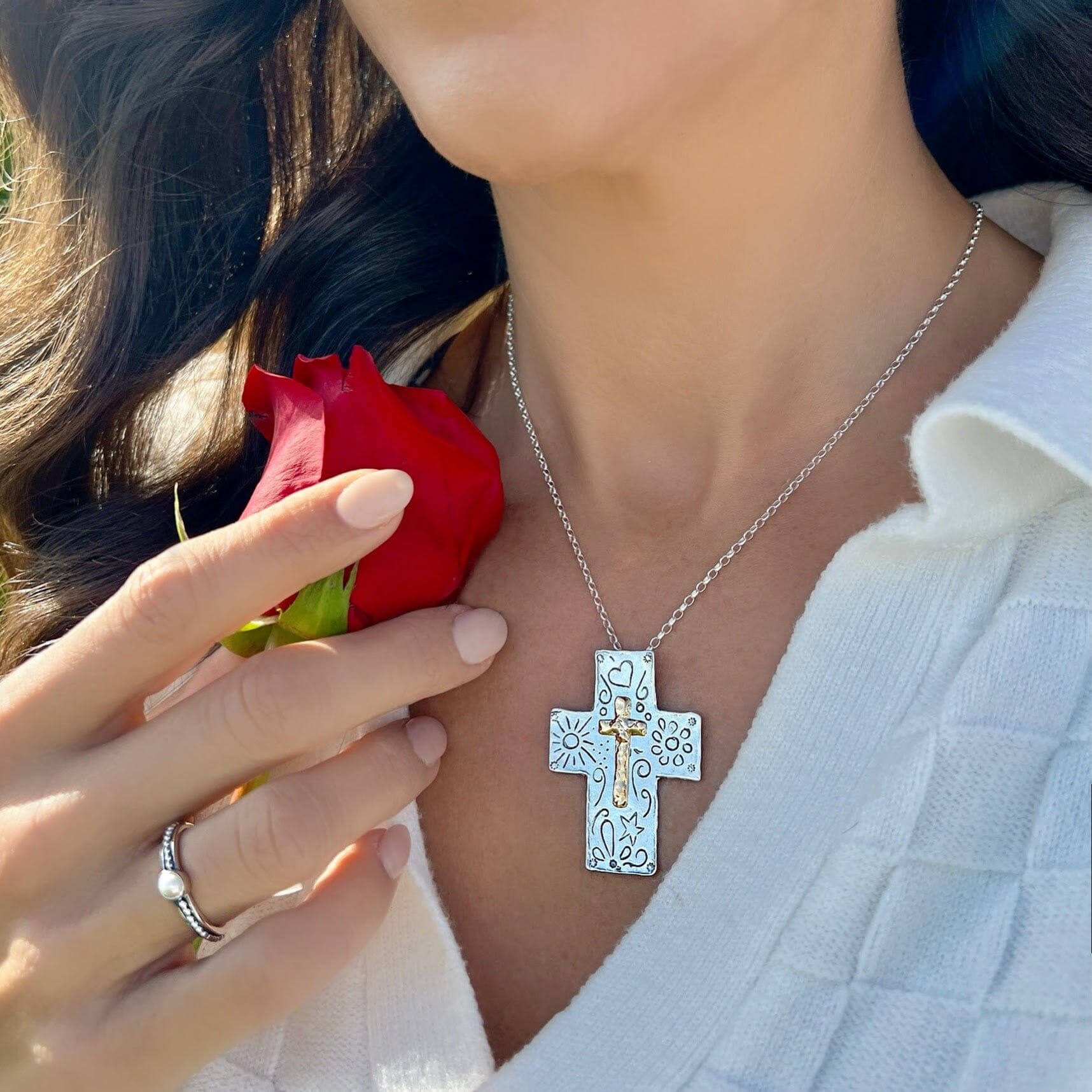 chunky silver designer cross necklace with a gold-plated center cross