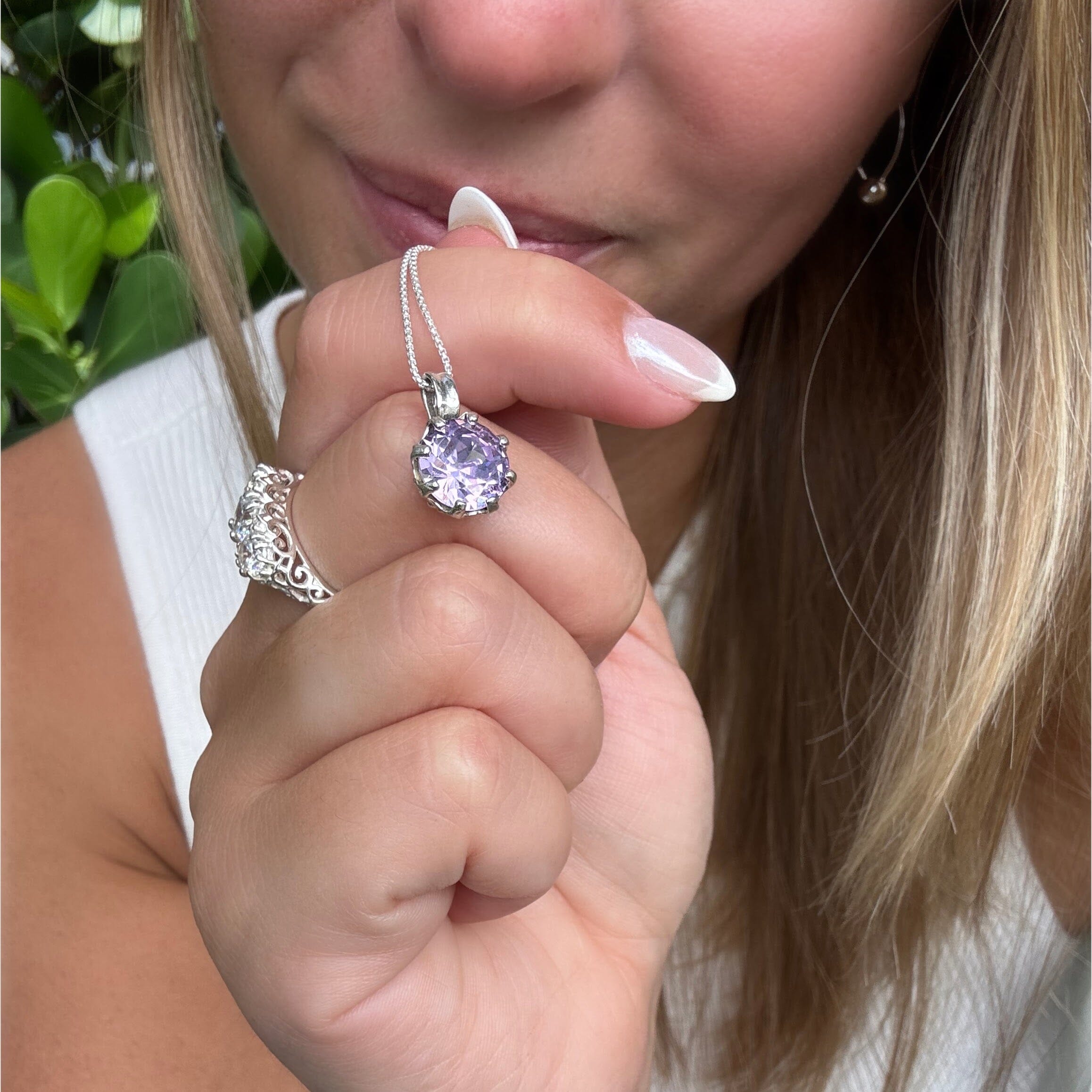 lilac stone prong-set in a sterling silver necklace pendant