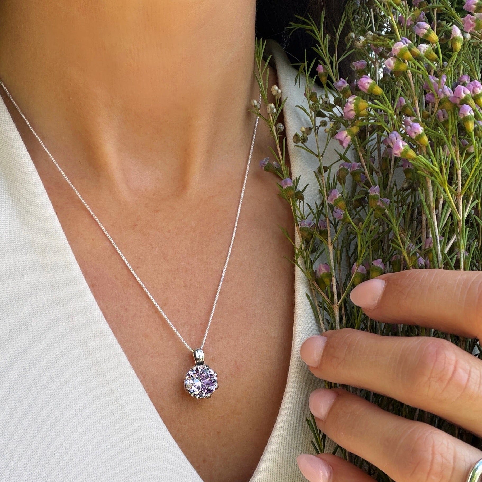 lilac stone prong-set in a sterling silver necklace pendant