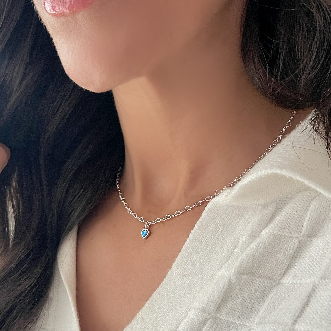 sterling silver heart chain necklace featuring a center heart dangle with a reconstructed opal center