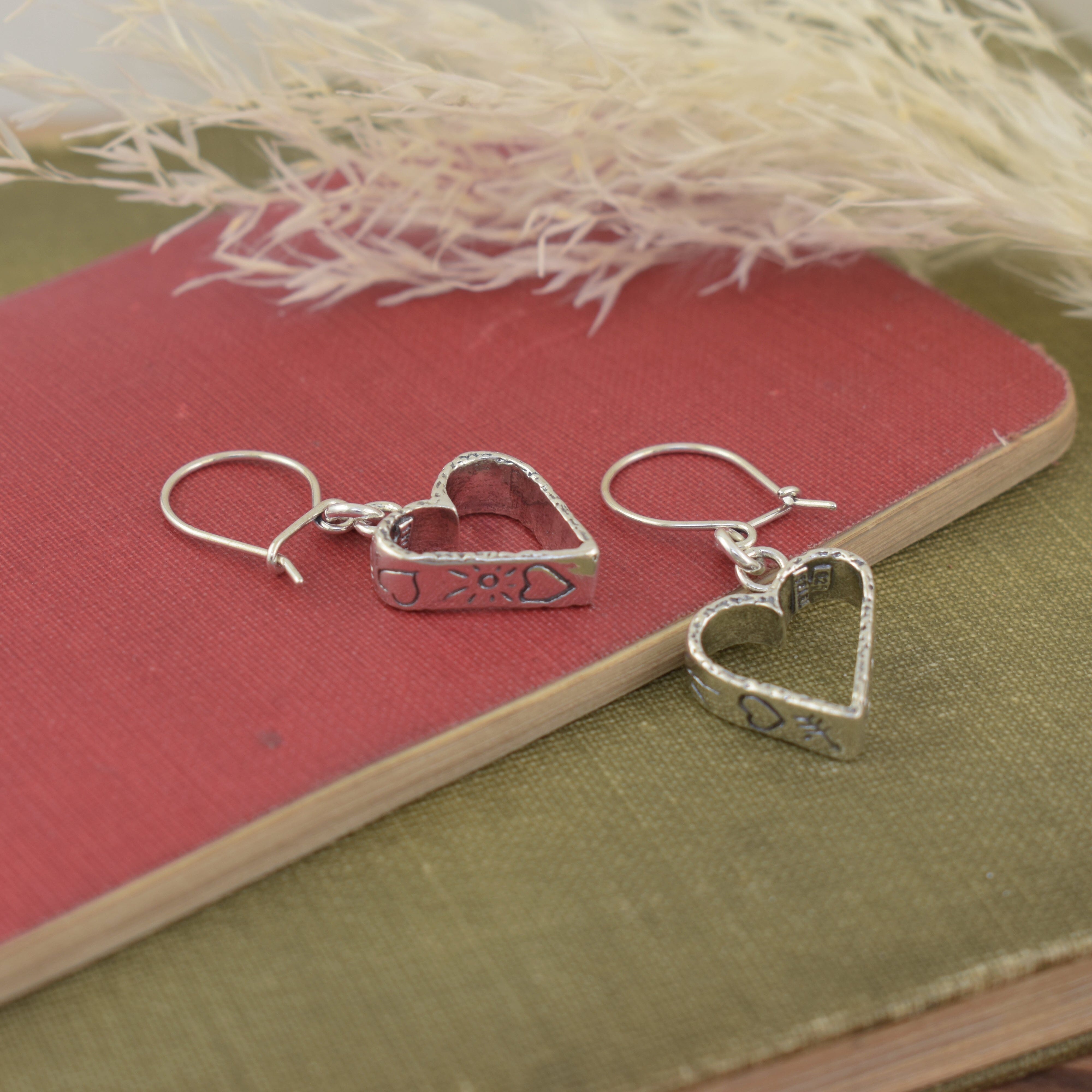 dangling heart shaped earrings with hand-stamped heart and sunshine details