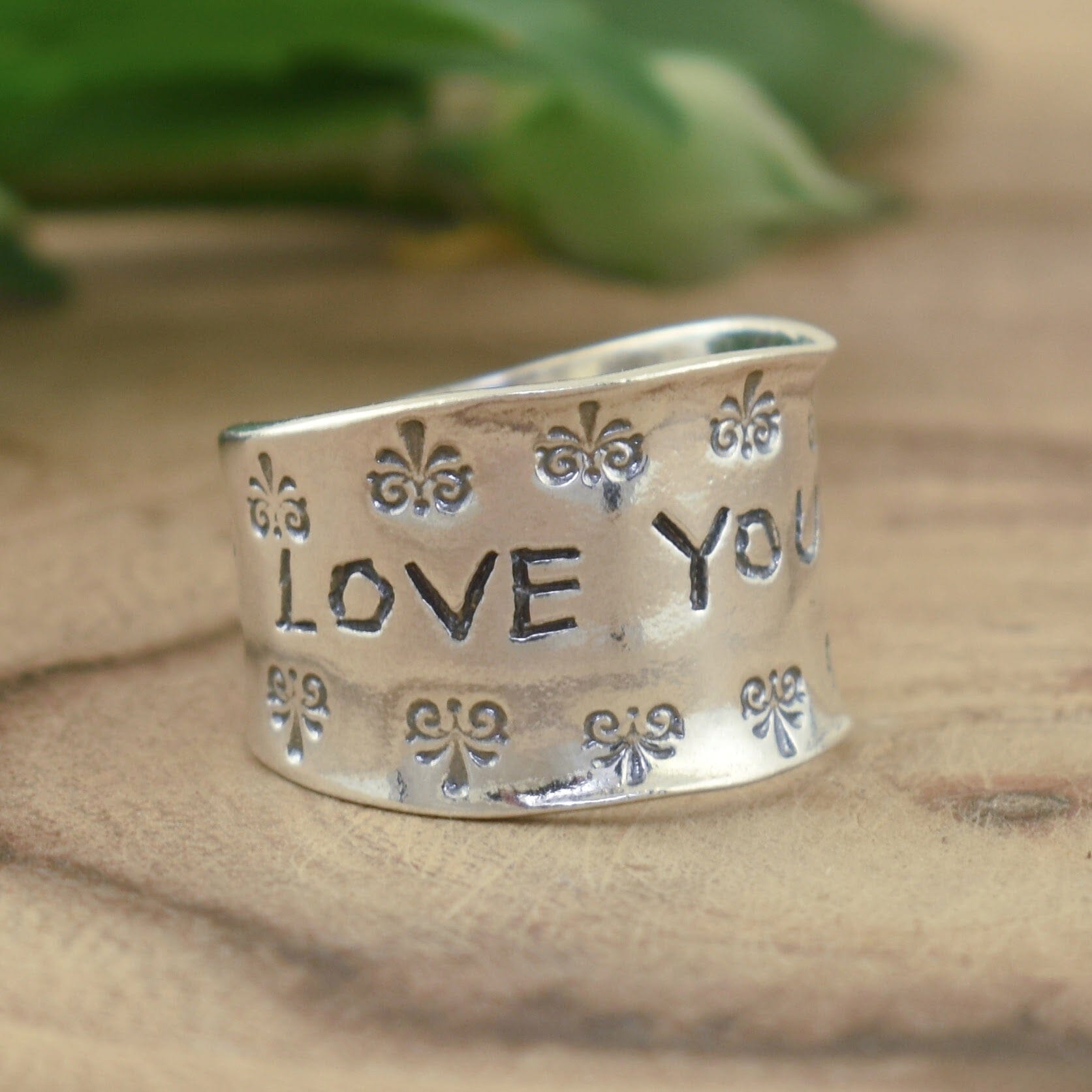 Wide band sterling silver ring engraved with "Love You More"