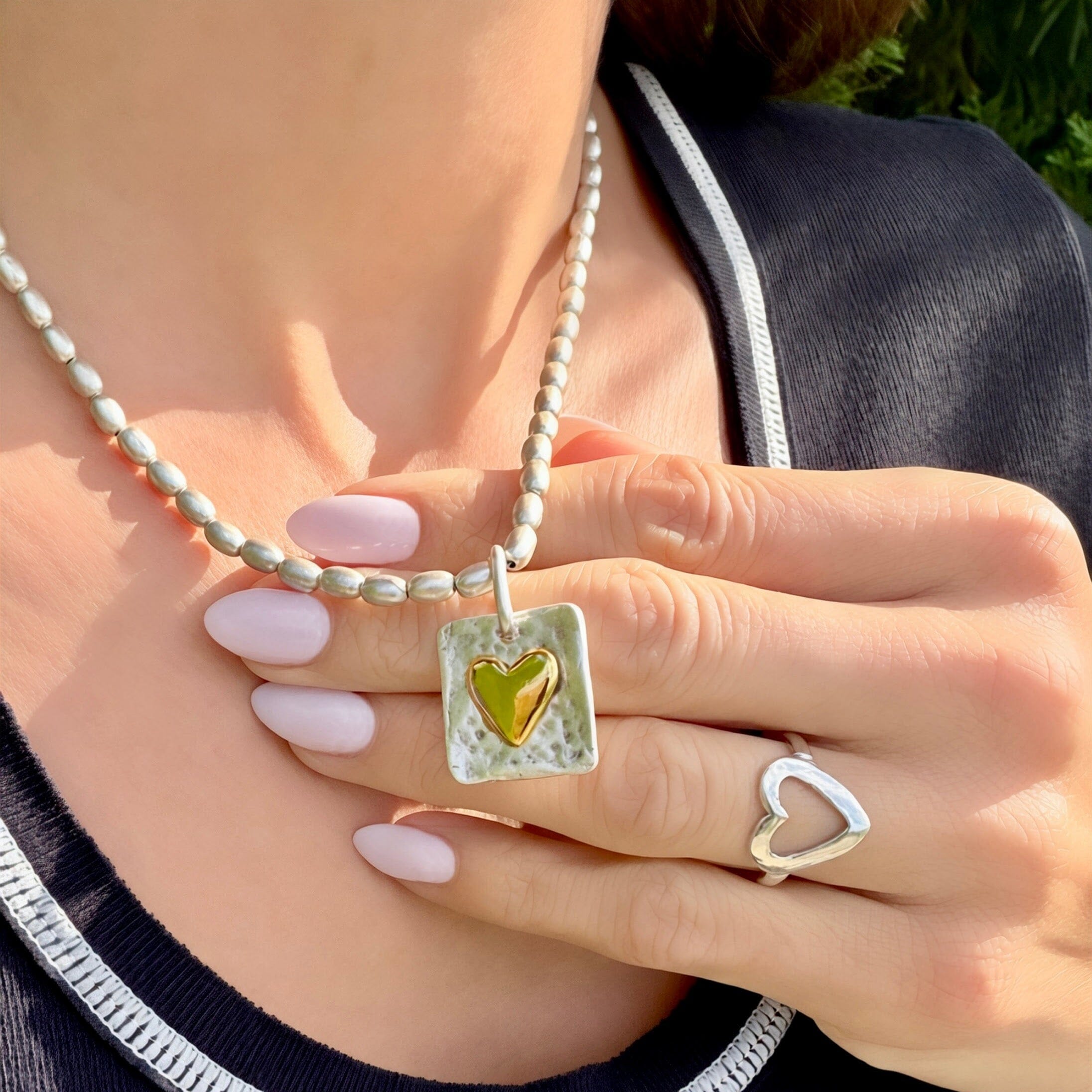 silver barrel beaded necklace featuring a two-toned hammered heart pendant