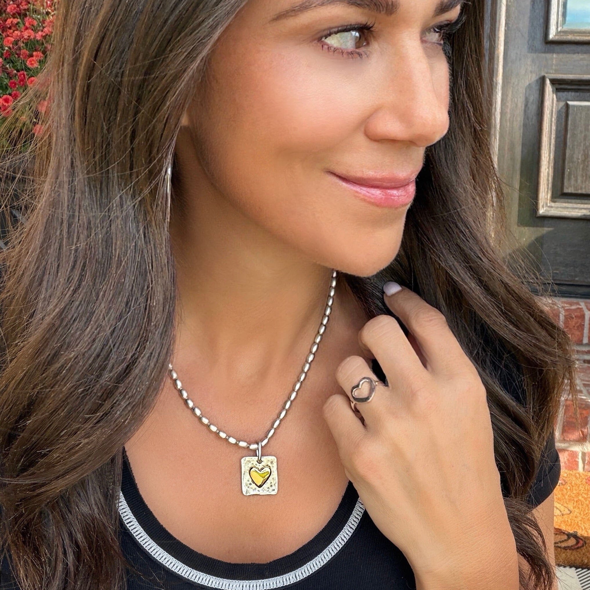 silver hammered necklace pendant with a gold heart