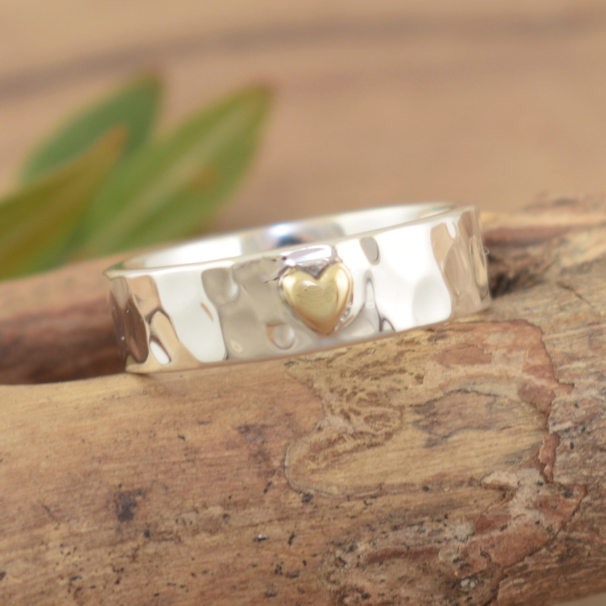 handcrafted sterling silver band ring with a brass plated heart