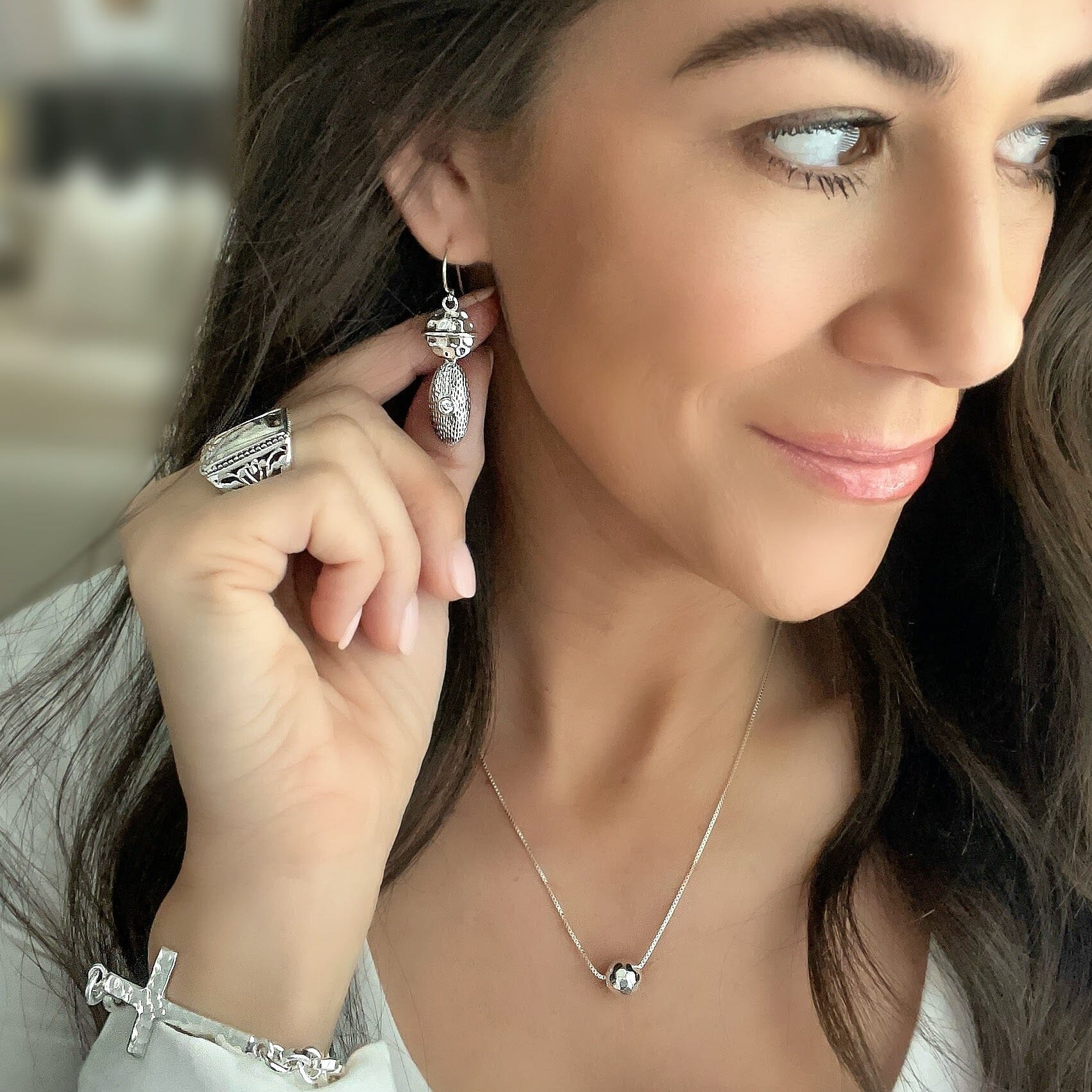 sterling silver earrings with a hammered circle connected to a oval detail with a cz stone paired with Cassidy ring and cherished one bracelet and bead it nk