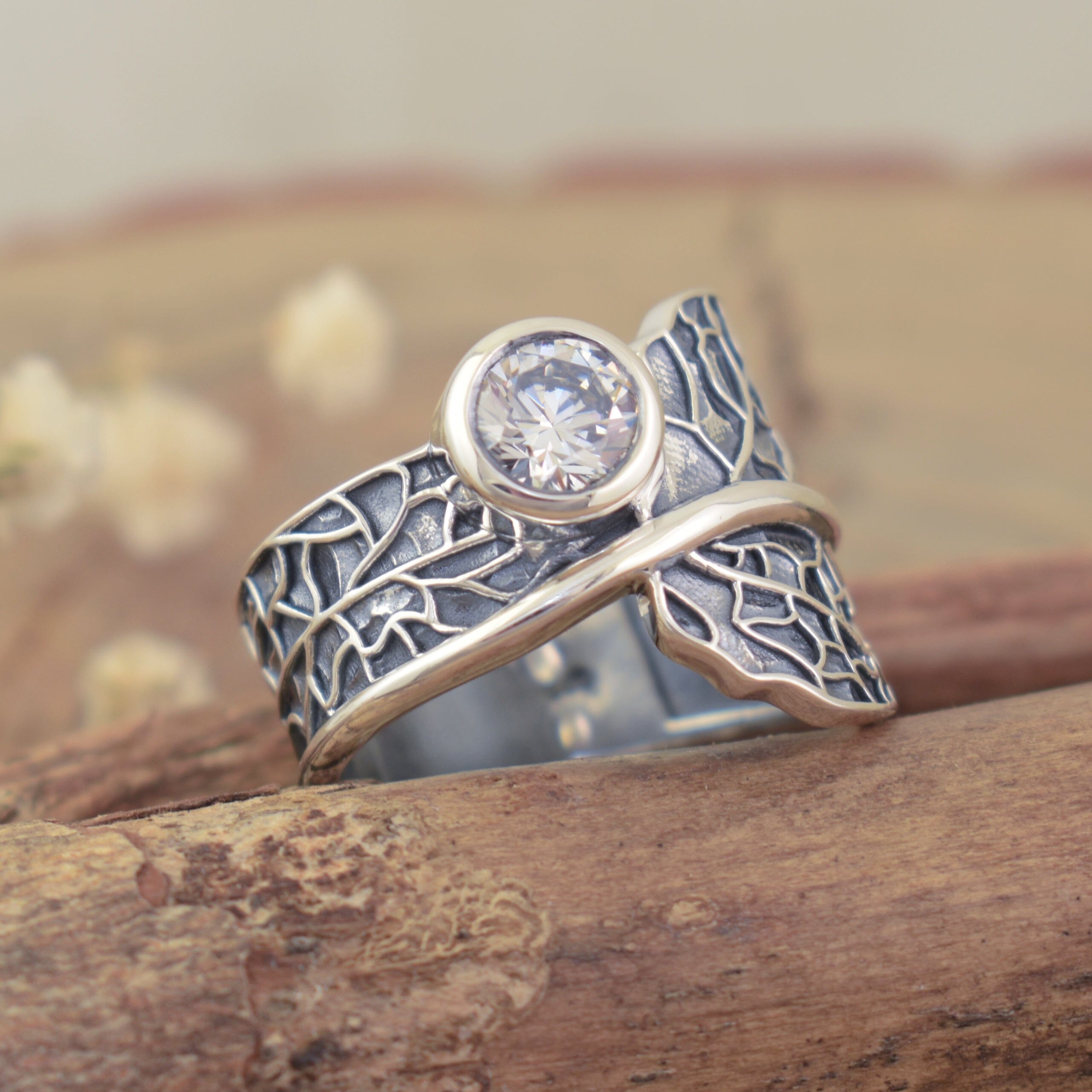 Handcrafted sterling silver ring featuring round cubic zirconia stone