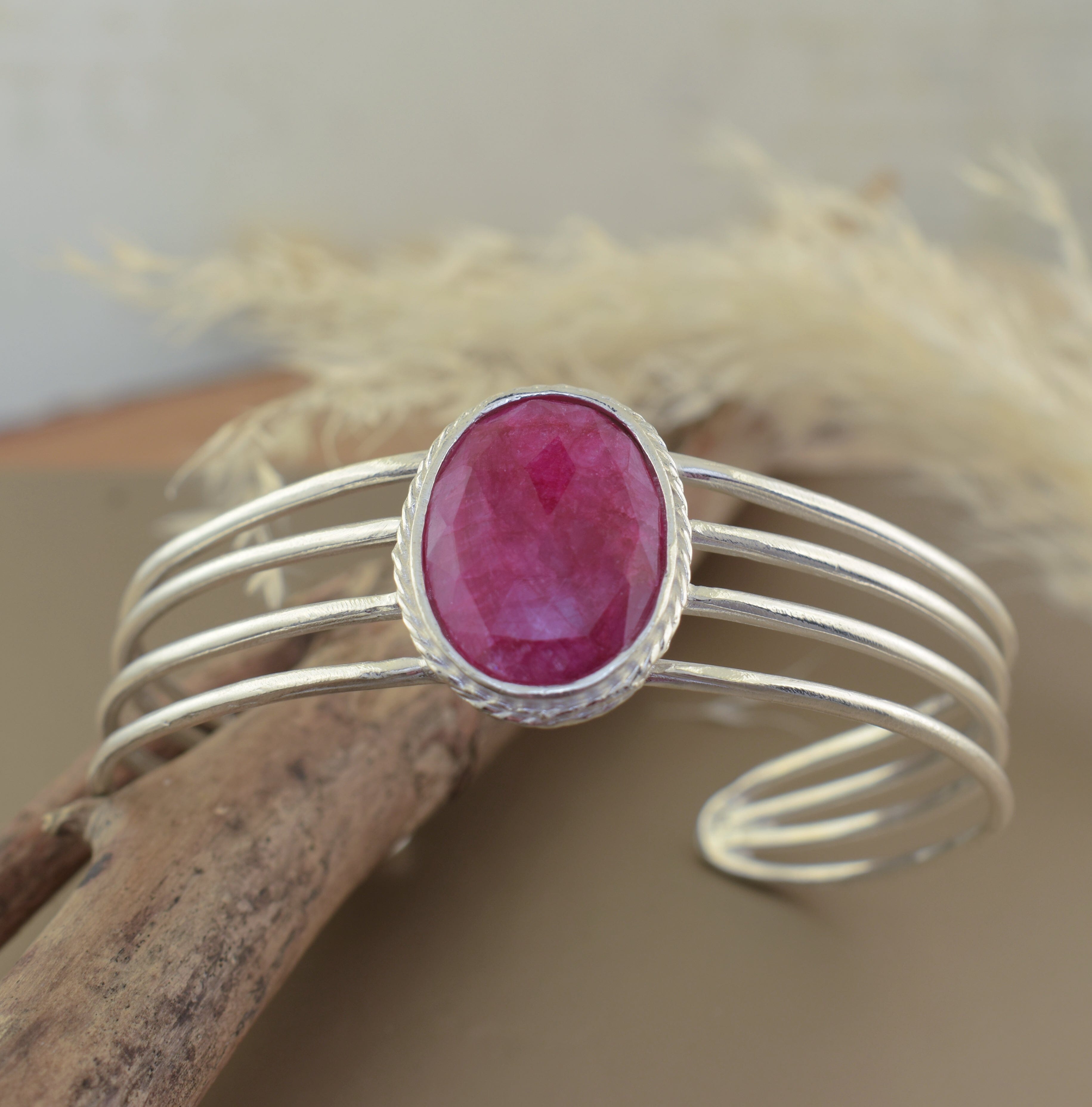 .925 sterling silver adjustable cuff with oval-shaped magenta stone