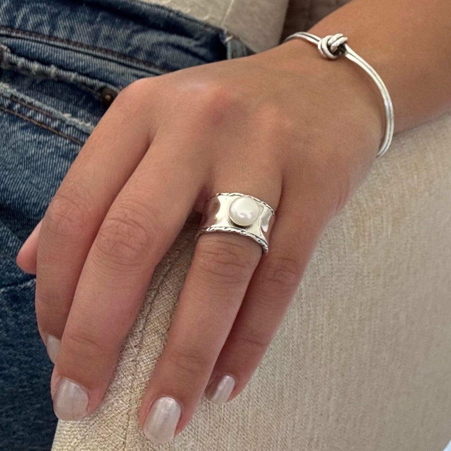 wide sterling silver band with a freshwater pearl on top