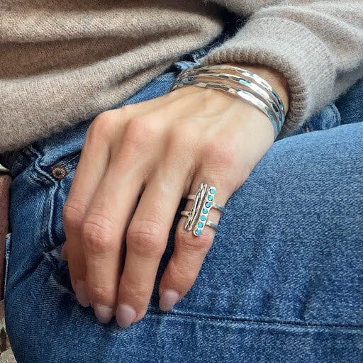 silver ring featuring two vertical bars with stripes and opals