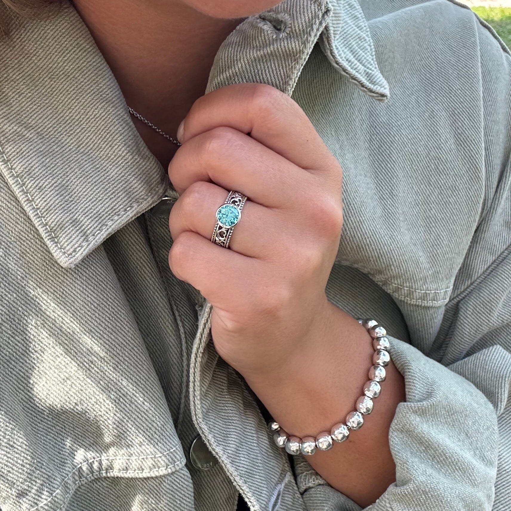 designer ring with silver beads on both sides of the bands