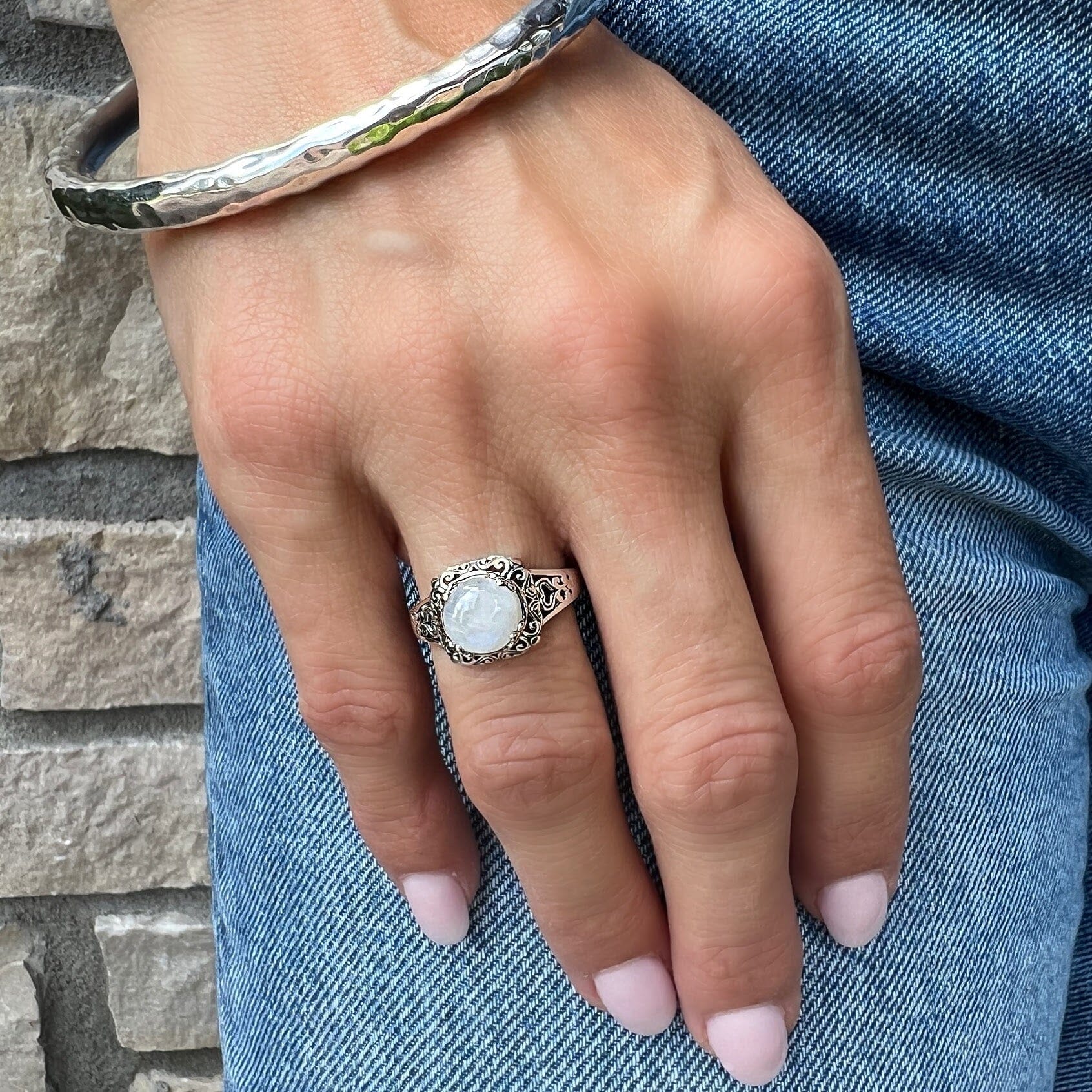 silver filligree ring with a rainbow moonstone center