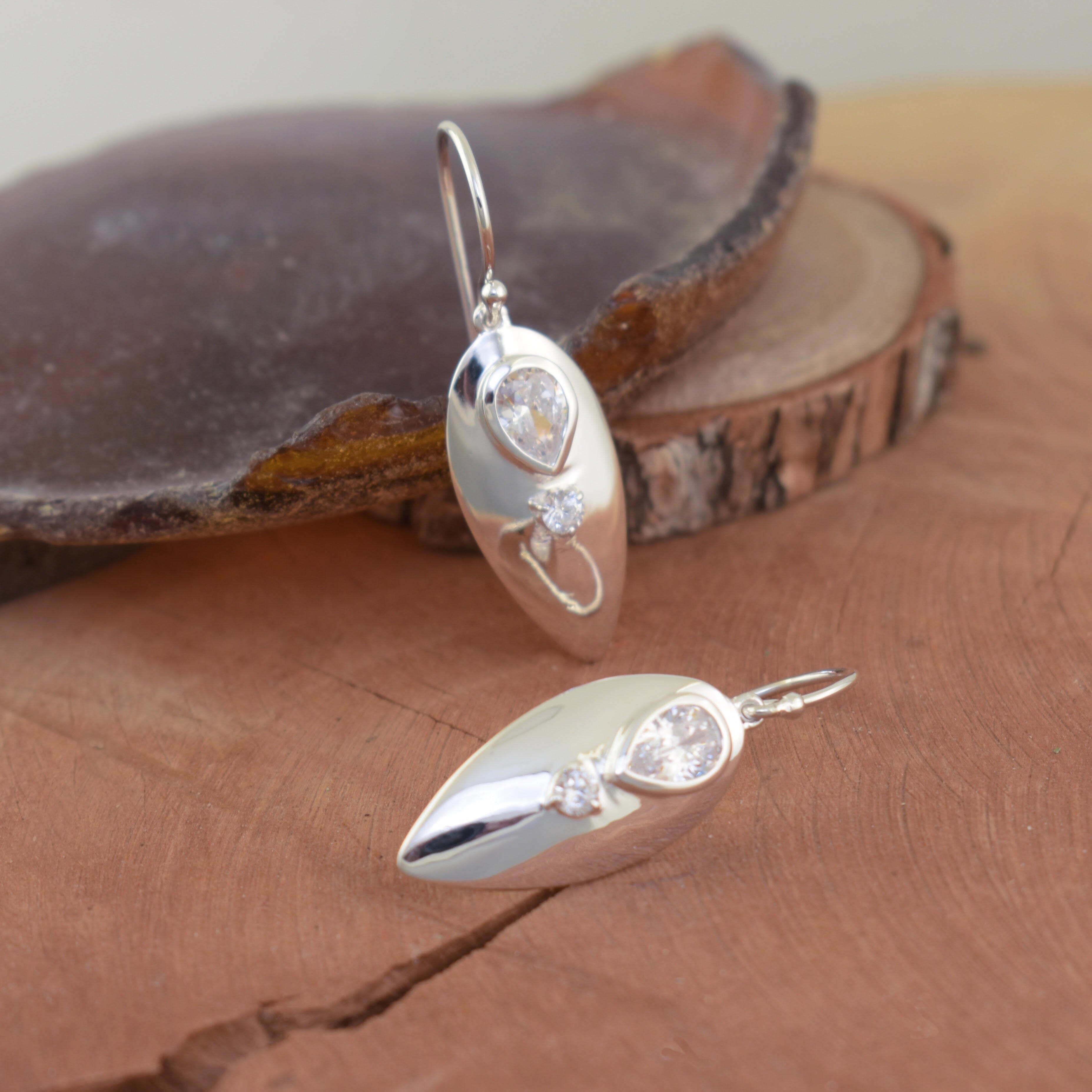 Sterling silver earrings with drop shaped clear CZ and a round cz