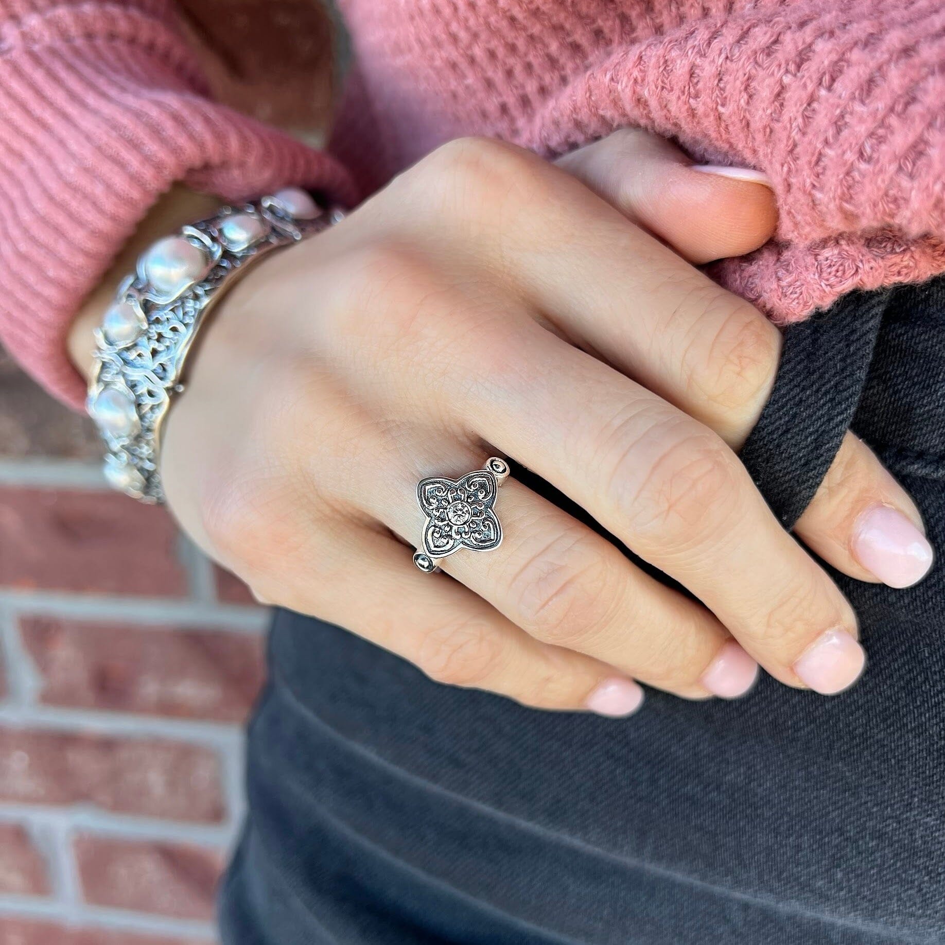 sterling silver ring with a delicate center CZ stone, surrounded by intricate vintage details.