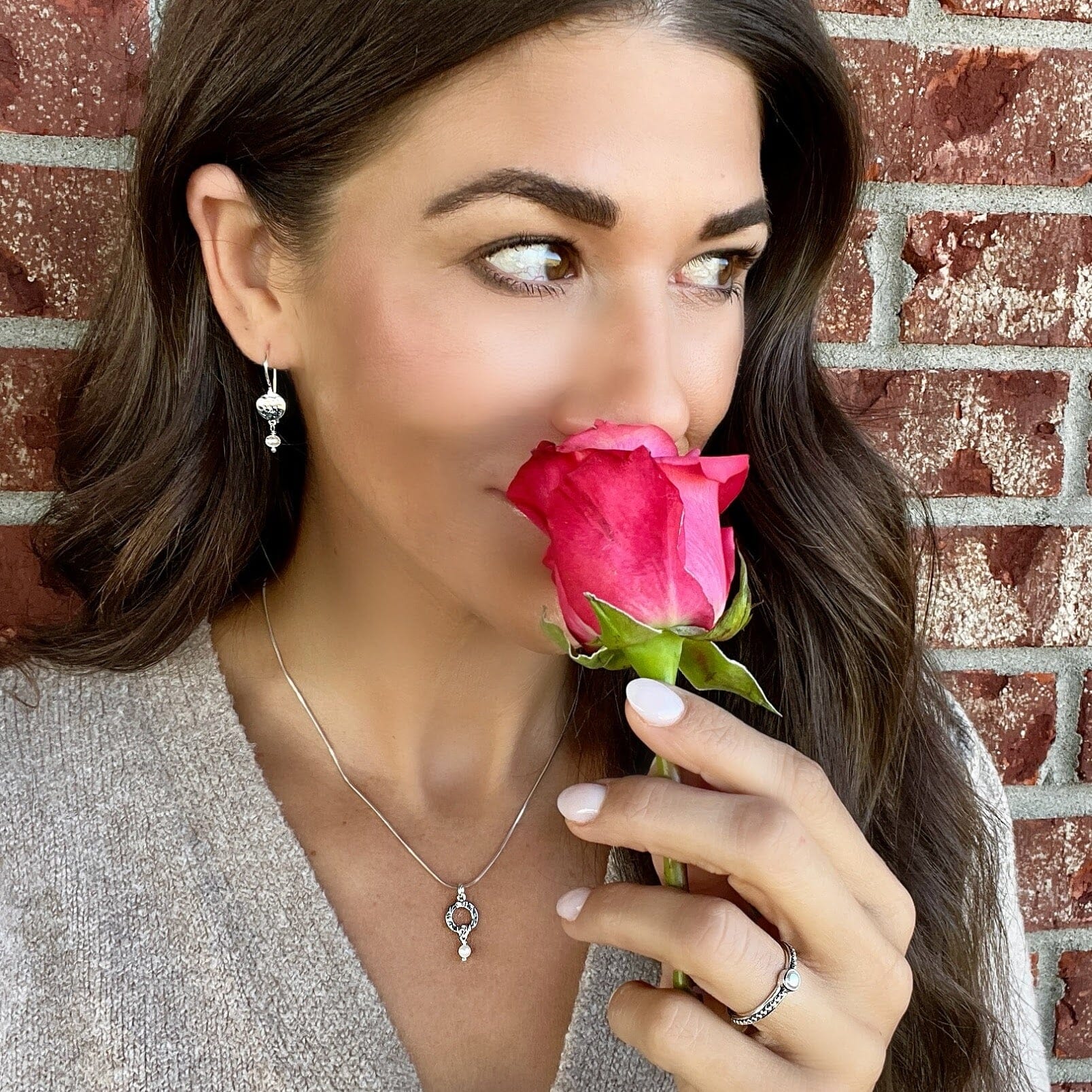 hook earrings with a silver disk and a pearl dangle