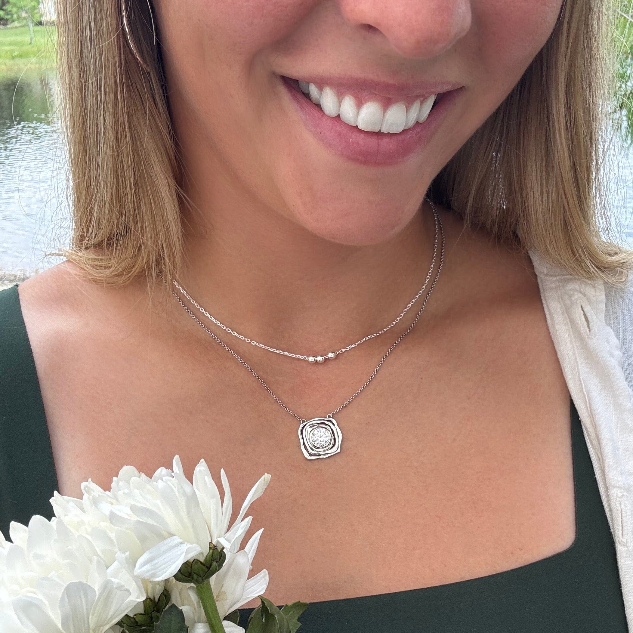 organic squared shaped silver necklace pendant with a round cubic zirconia center