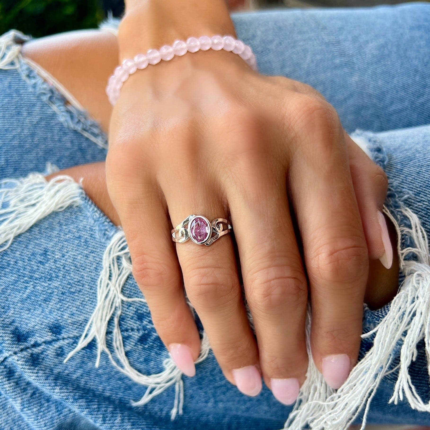sterling silver pink cz stone with a wave look on the band