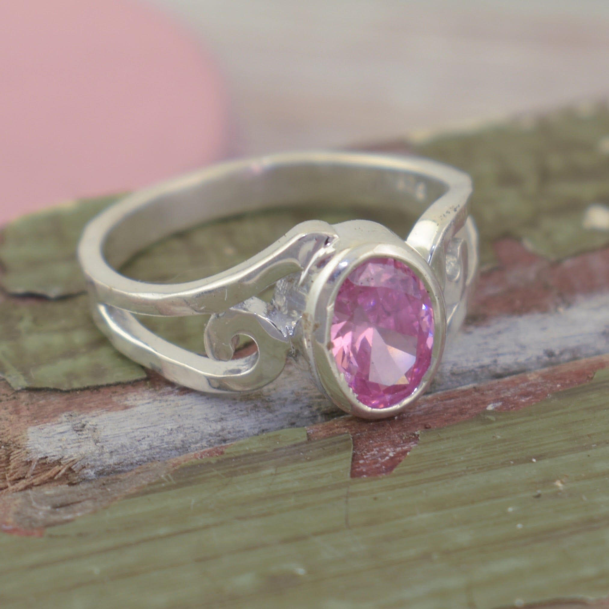 soft pink CZ stone with a wave design band