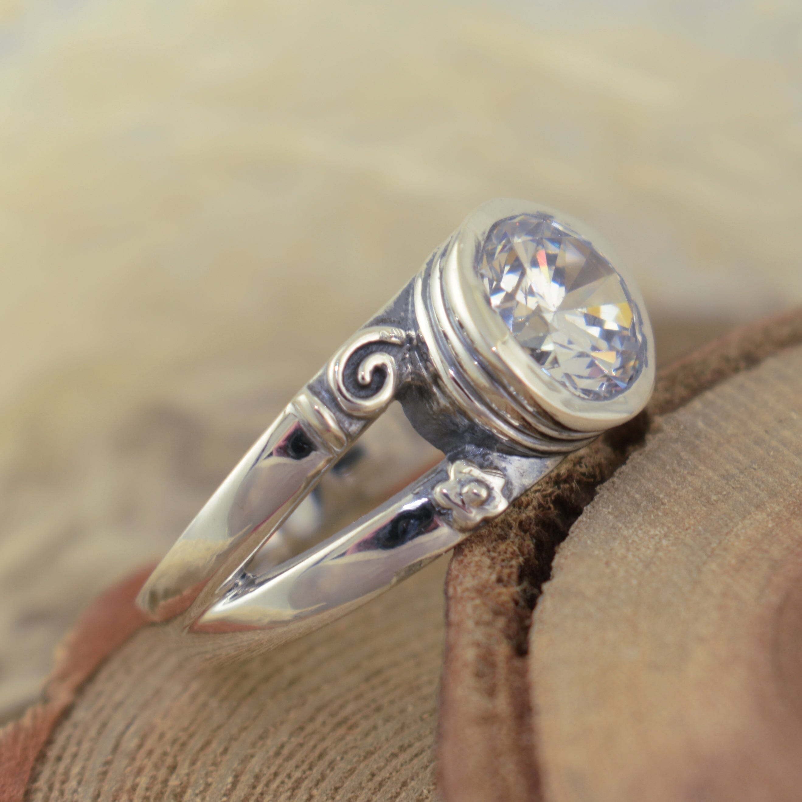 silver designer ring featuring a round, bezel set cz stone - Playful Pirouette