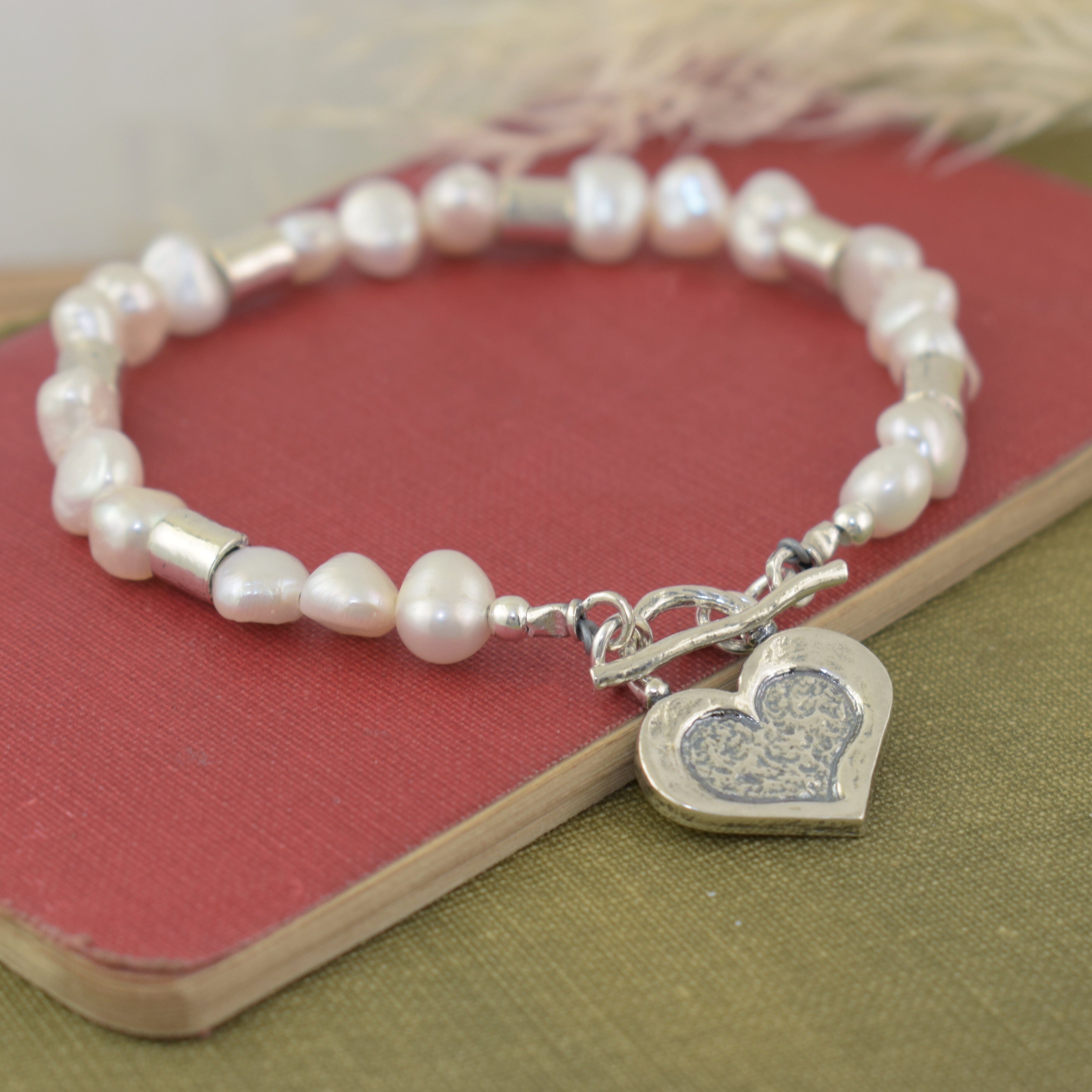 wire pearl bracelet featuring sterling silver barrel beads and a heart shaped pendant