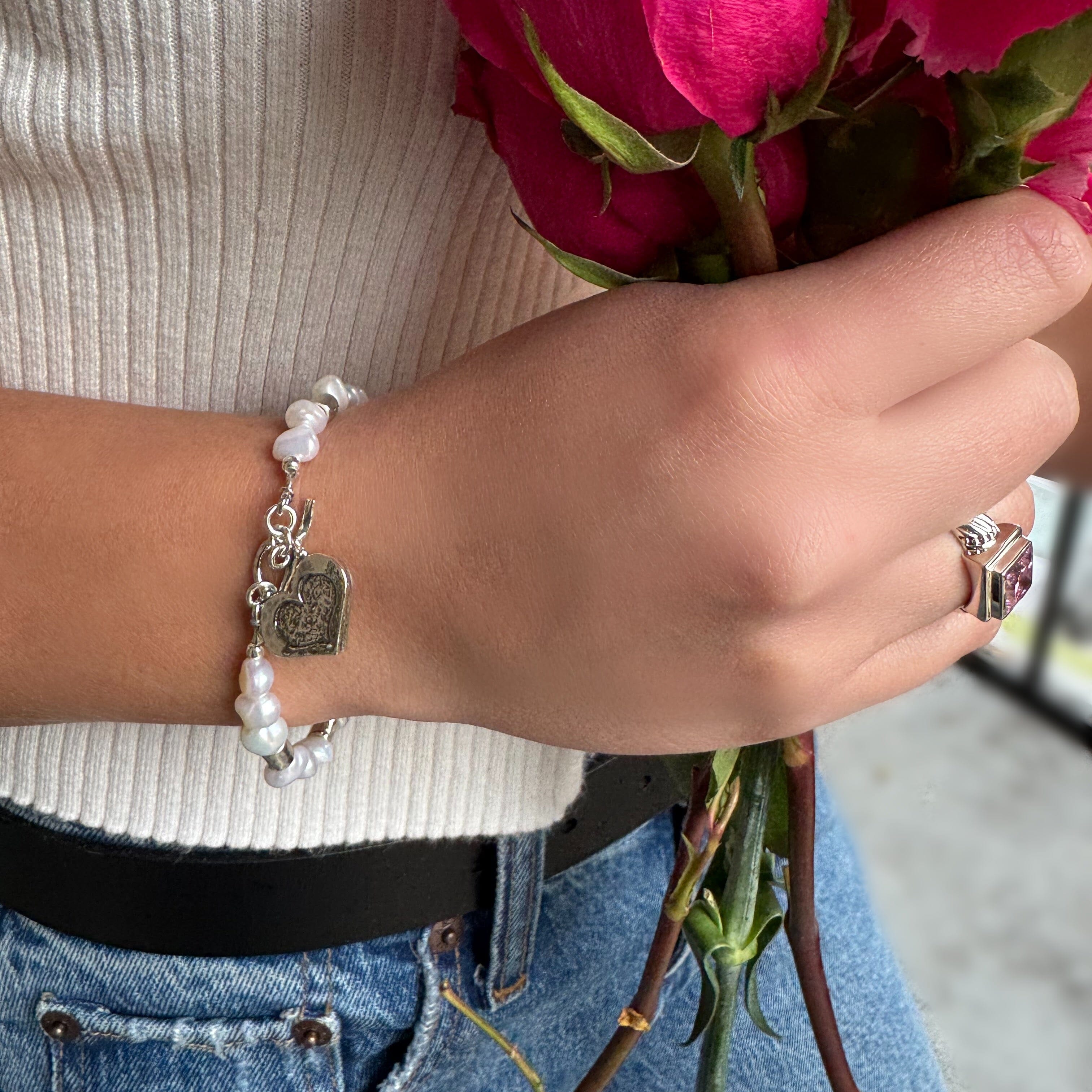 Pearl bracelet with sterling silver spacers and a sterling silver hand crafted heart charm