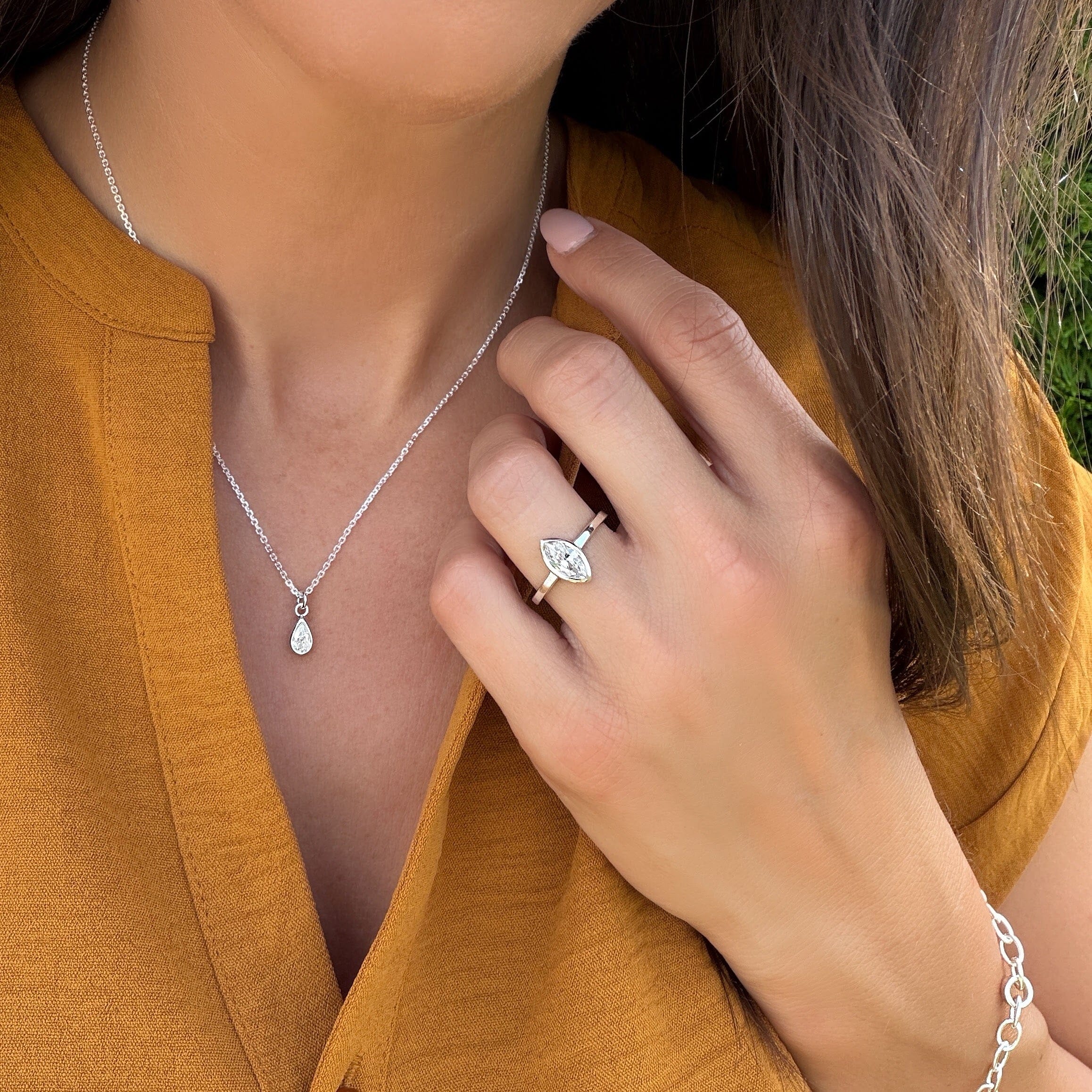 minimalist style sterling silver ring featuring a marquise-cut cubic zirconia