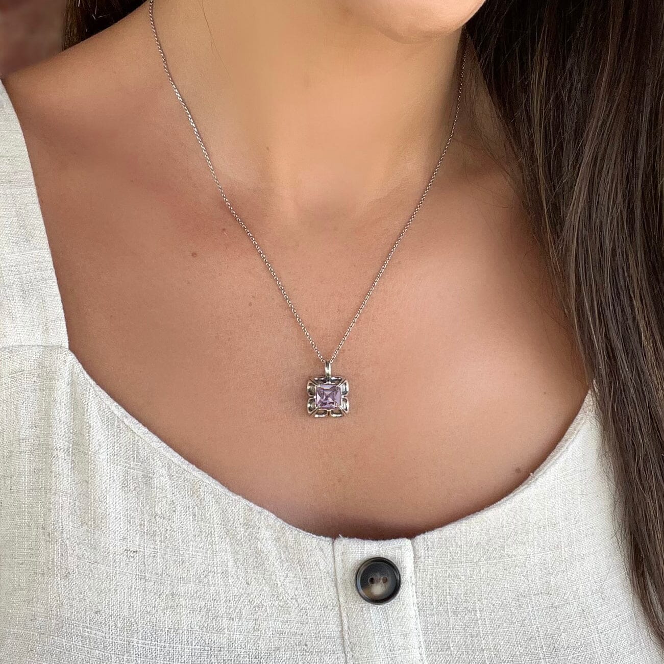 Sterling silver necklace featuring plum pink colored cz stone