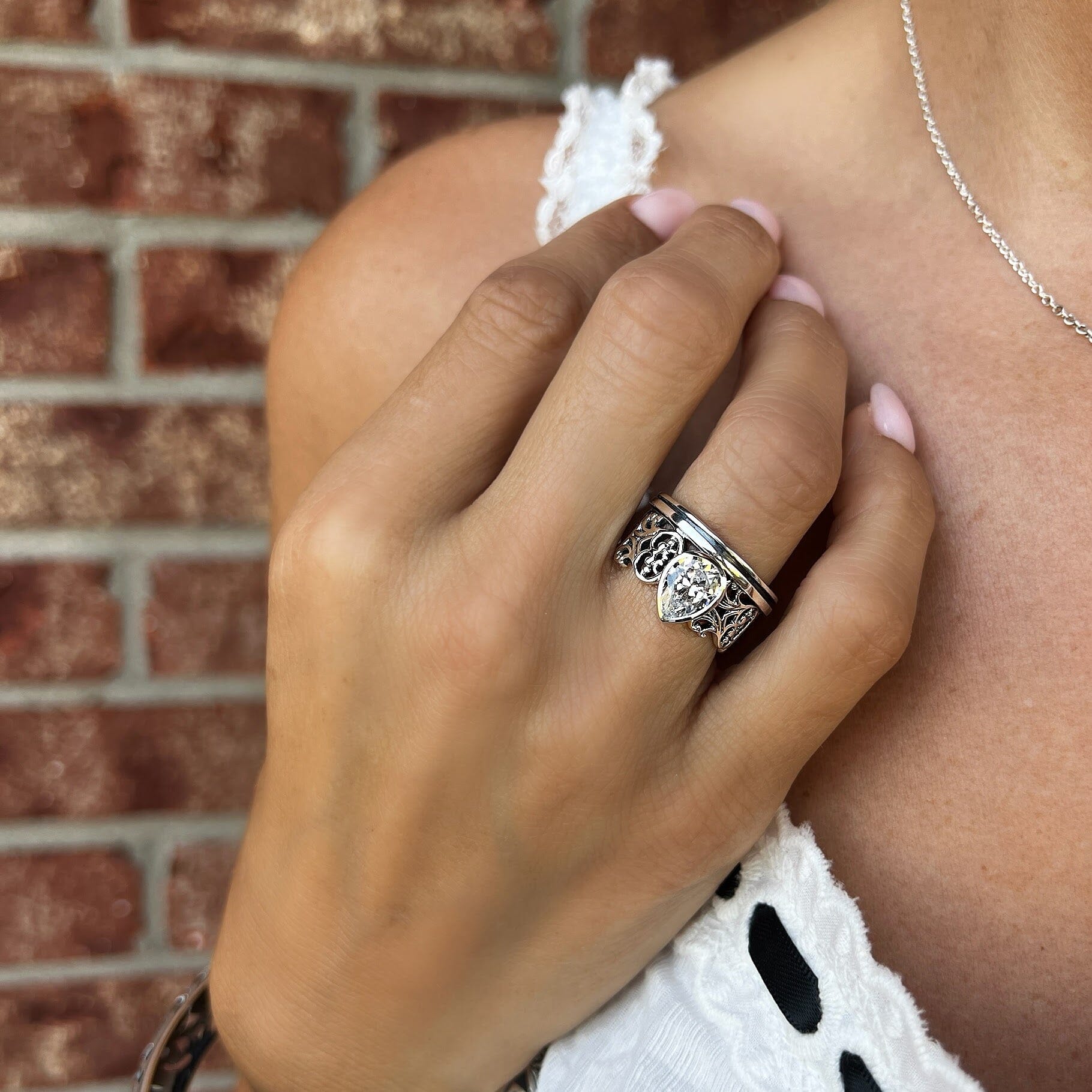 .925 silver wide band ring featuring a cubic zirconium stone bezel set