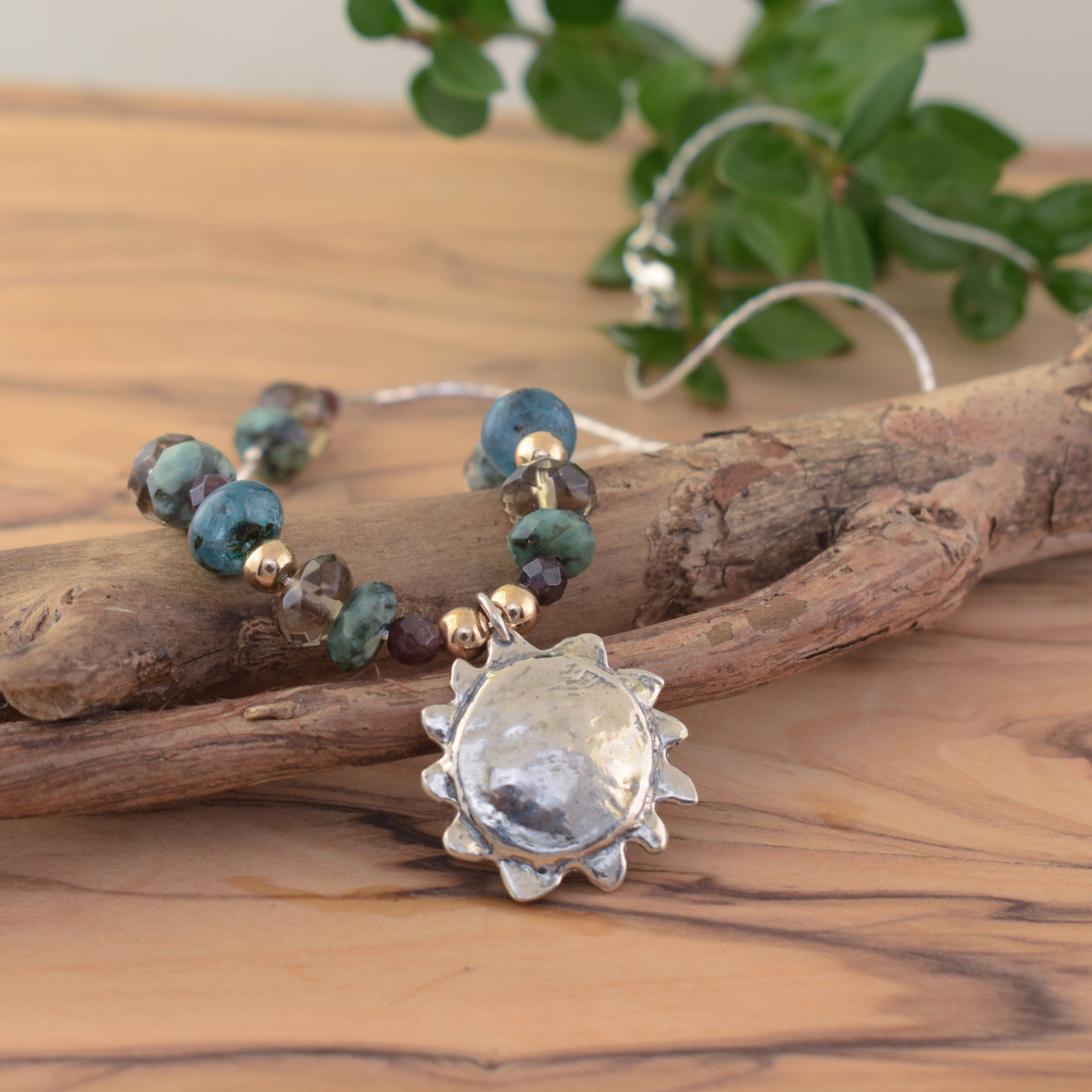 Hand crafted sterling silver sun necklace with Garnet, Turquoise, Kyanite, Hematite, and Smoky quartz stones