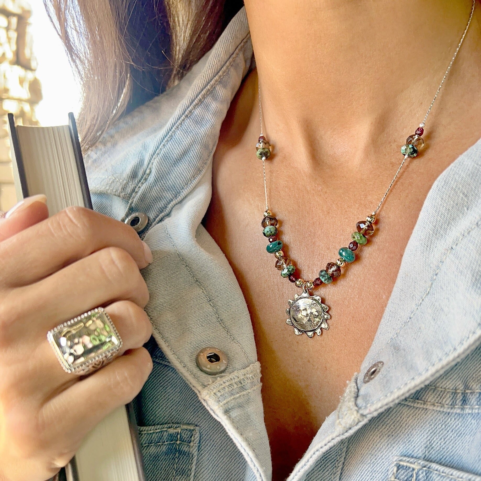 sun necklace featuring sterling silver and gold plated accents and an assortment of different colored beads