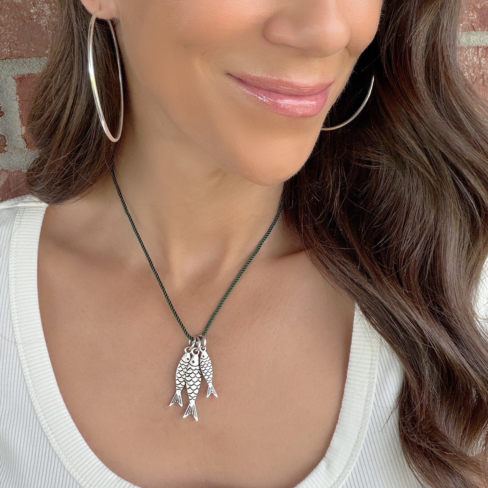 fish necklace with dark green cotton cording
