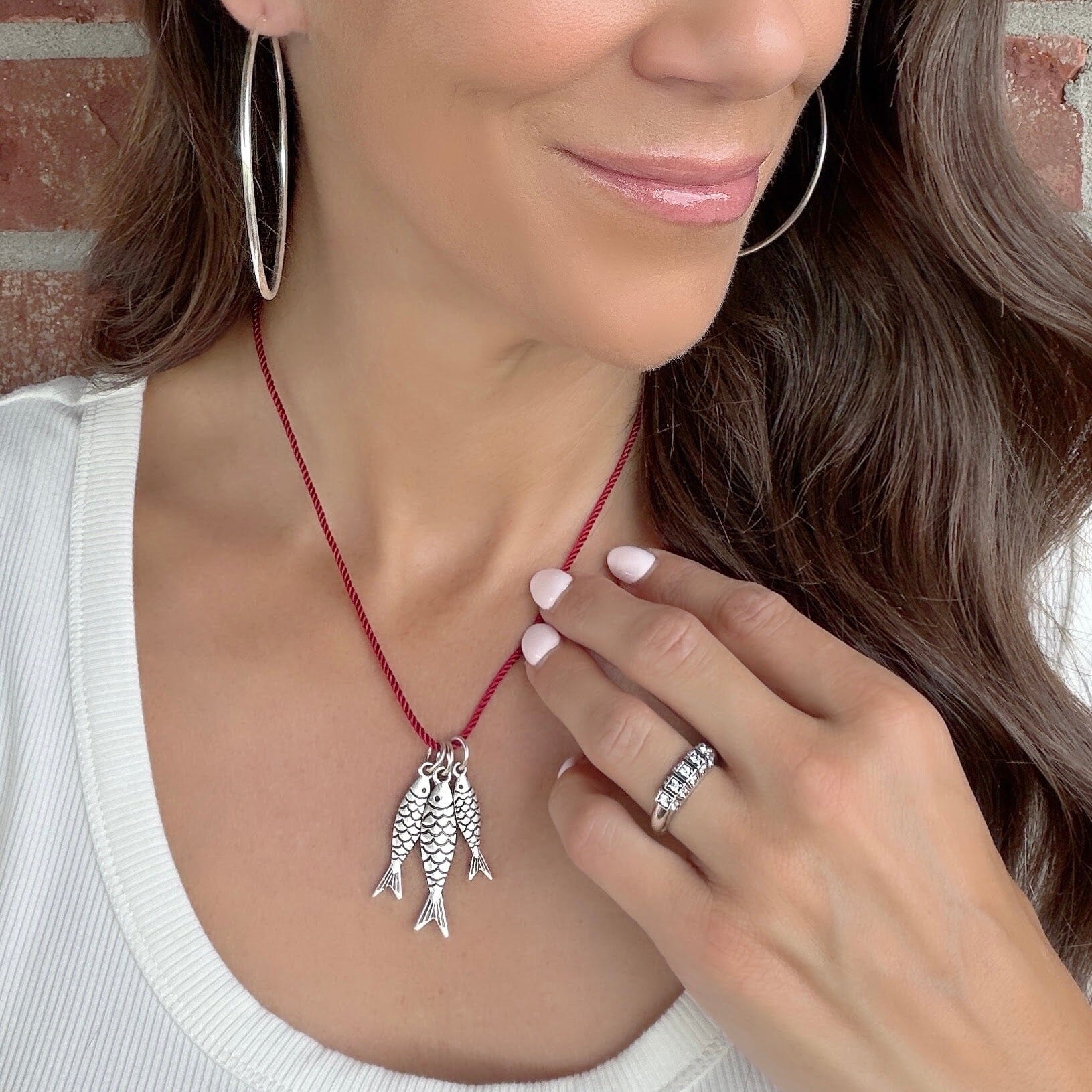 red cording necklace with silver fish pendants