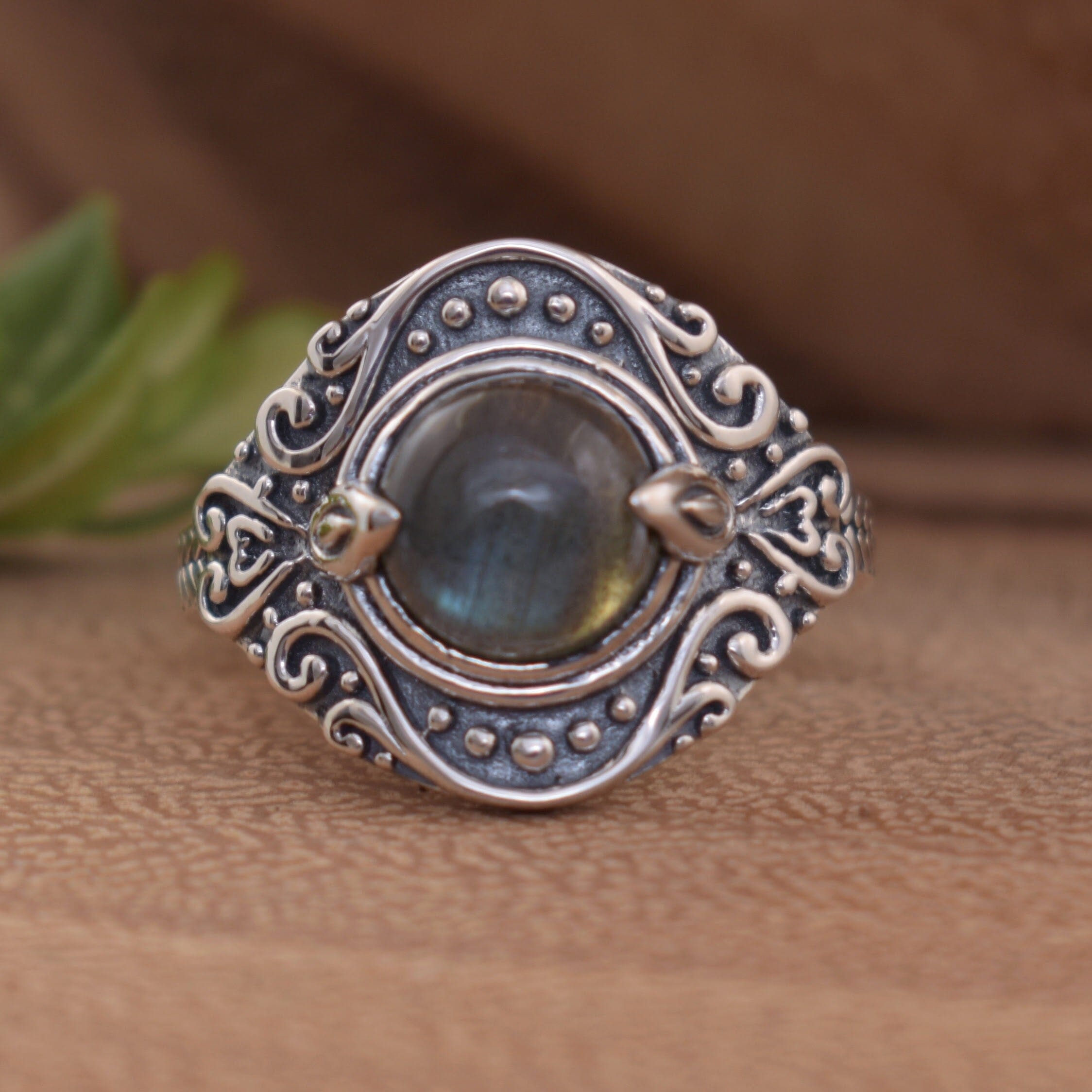 Designer sterling silver ring featuring swirl and dot detail and large labradorite stone