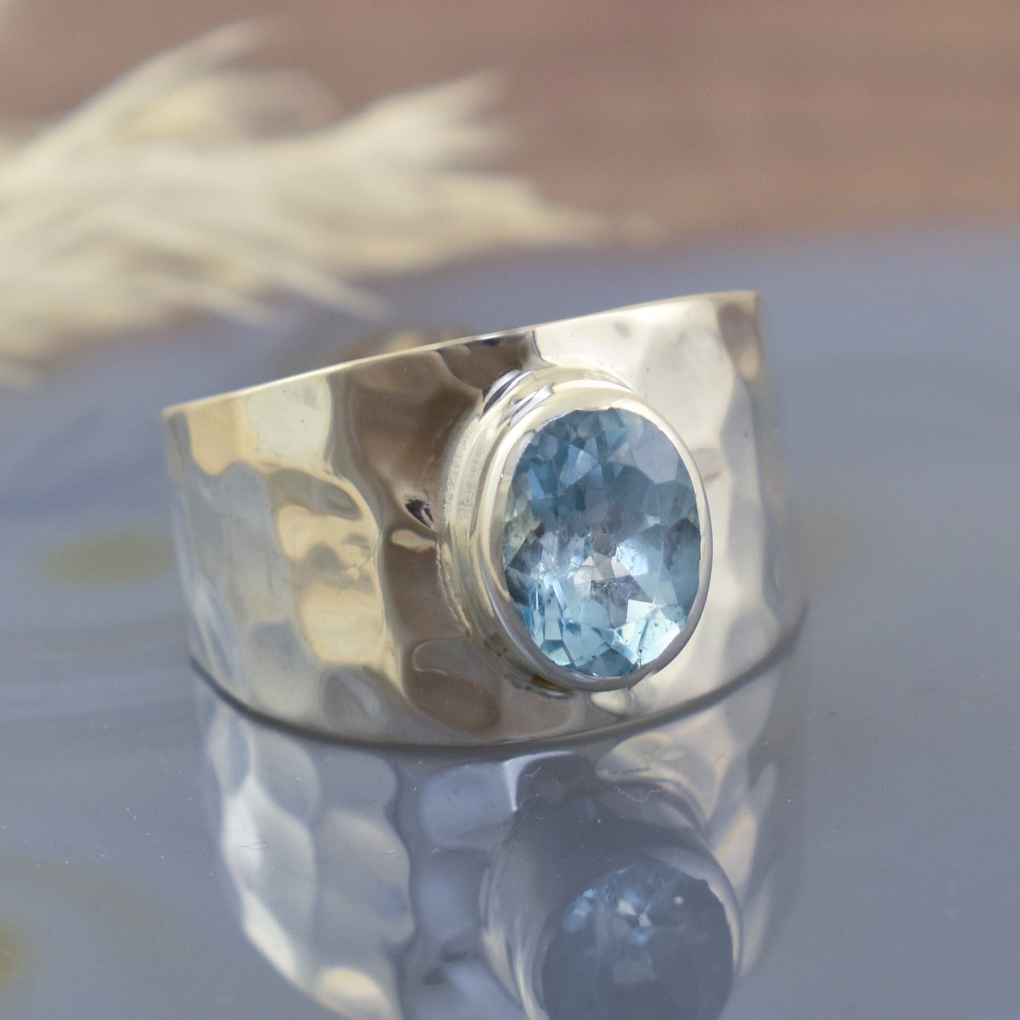 sterling silver hammered ring with oval blue topaz center