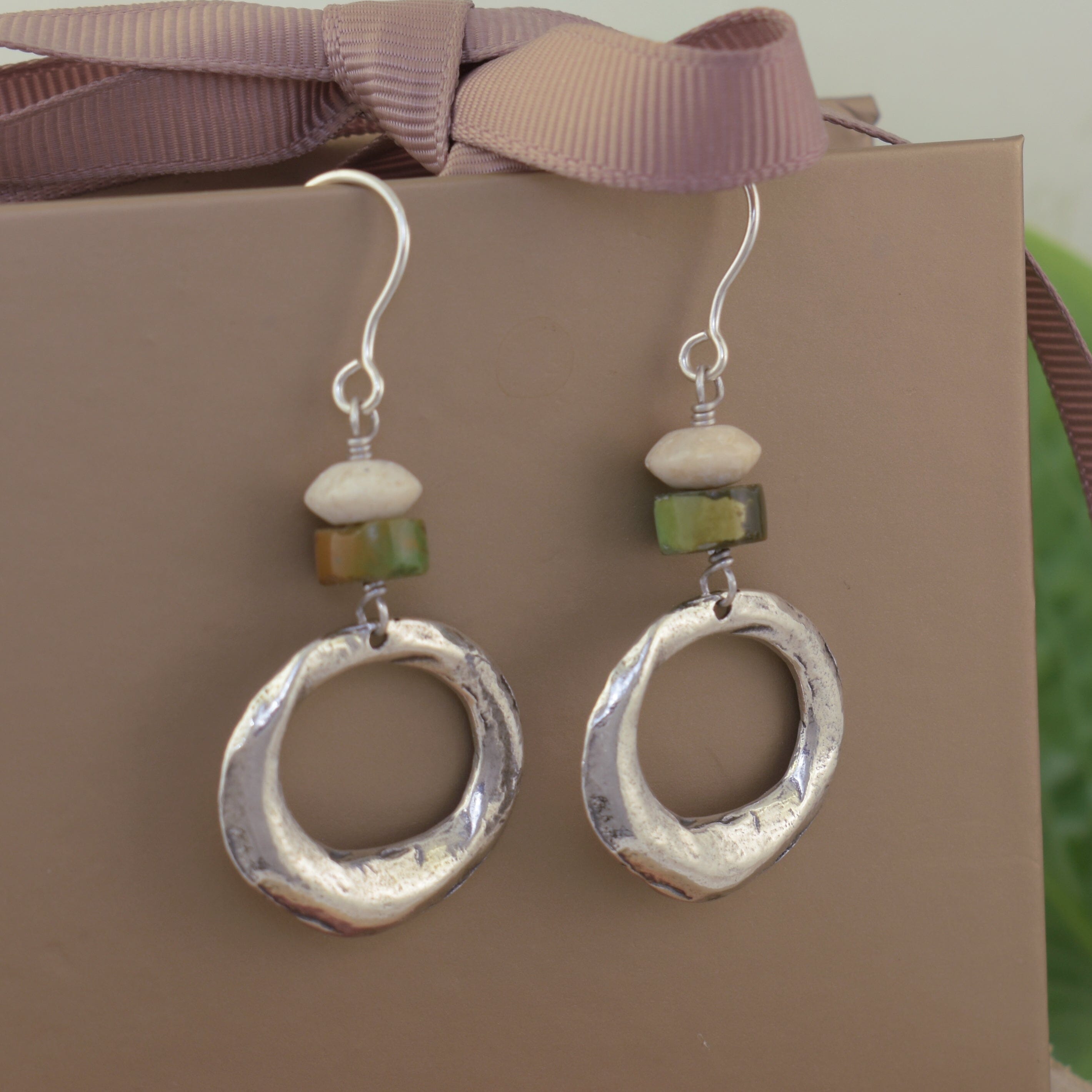 Silver hoop earrings with green and beige beads on French wires