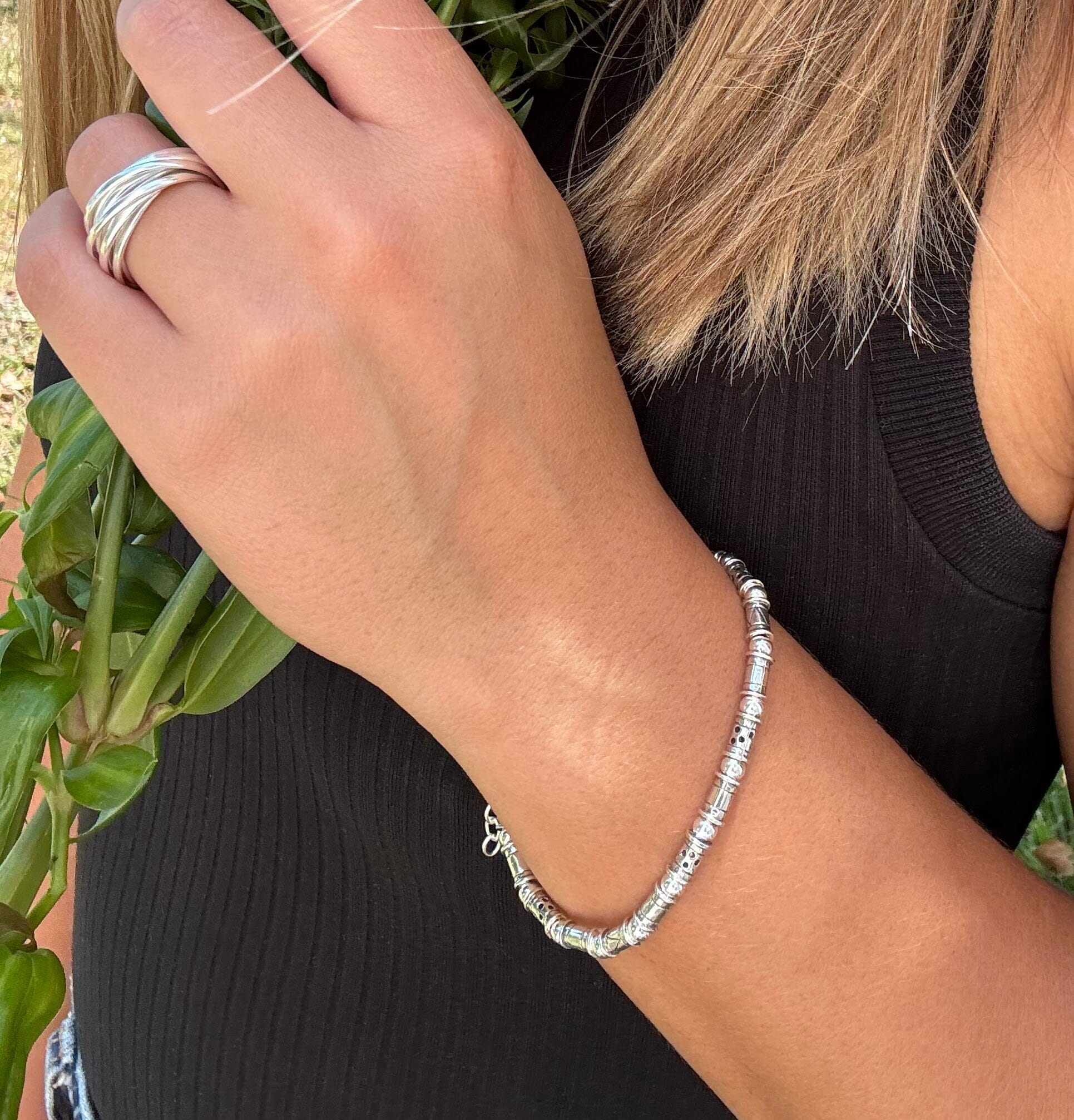 thin silver designer bracelet featuring tube and round beads