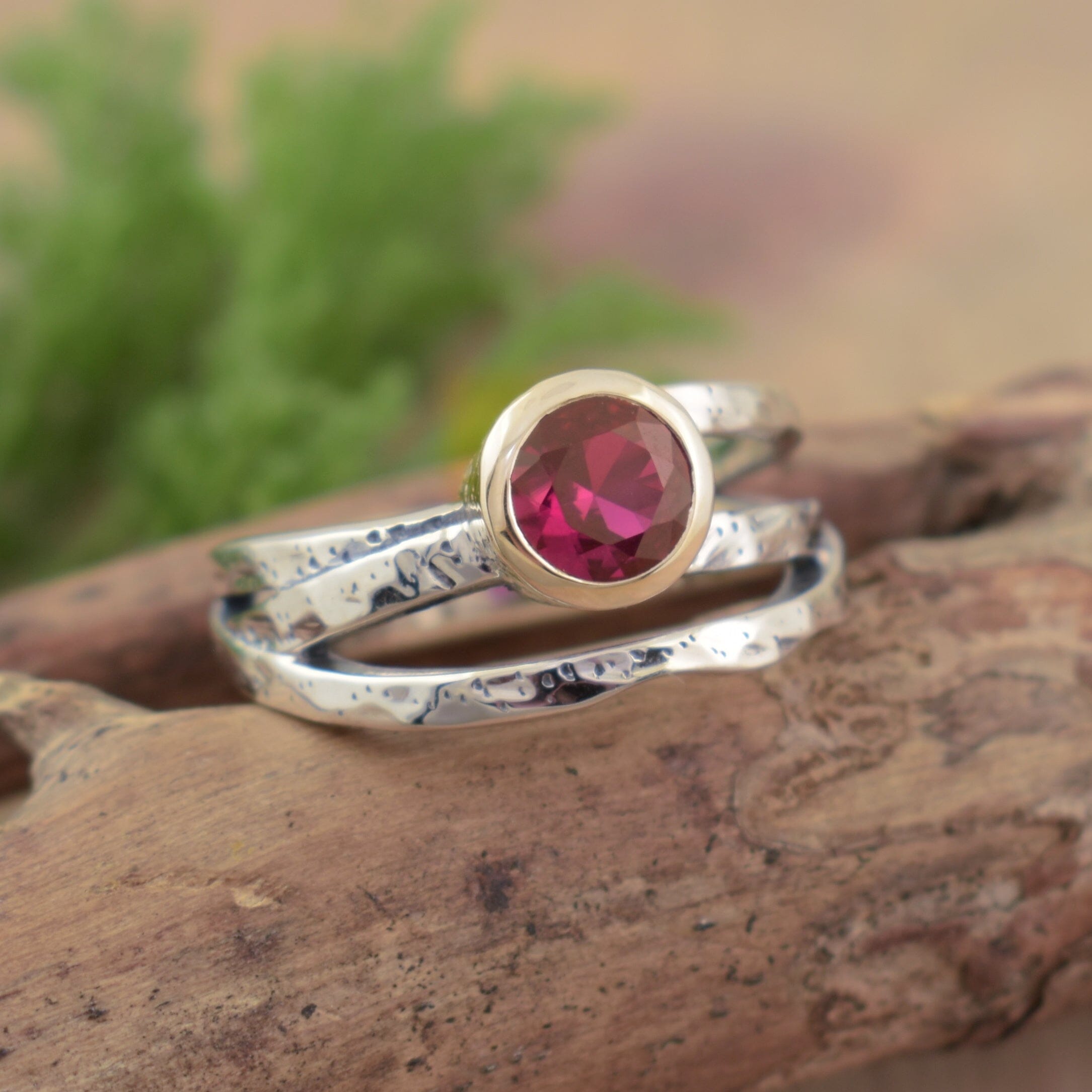 organic hammered ring with a ruby cubic zirconia stone bezel set in sterling silver