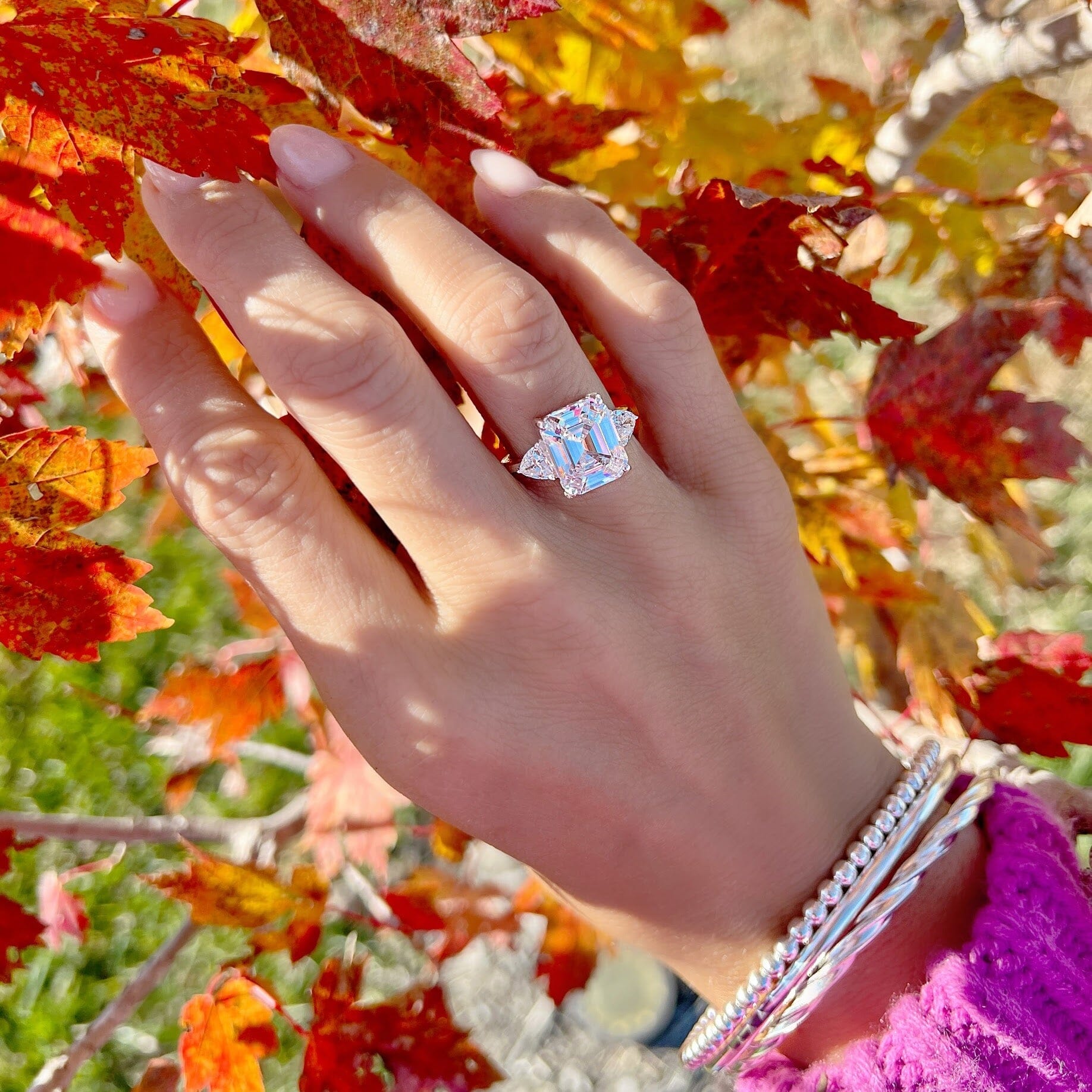 sterling silver engagement style ring featuring prong-set emerald-cut and triangle-cut cz stones